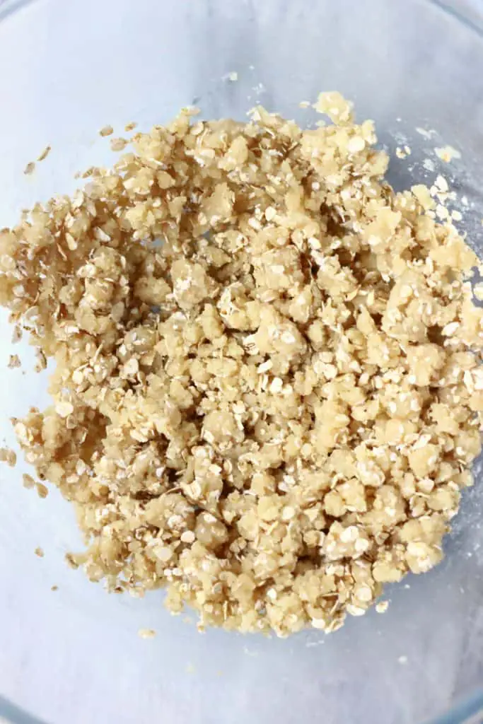 Raw pastry dough with oats in a glass mixing bowl