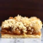 Apple pie bar on a marble slab against a dark brown background