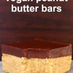 Peanut butter bar topped with dark chocolate with a bite taken out of it