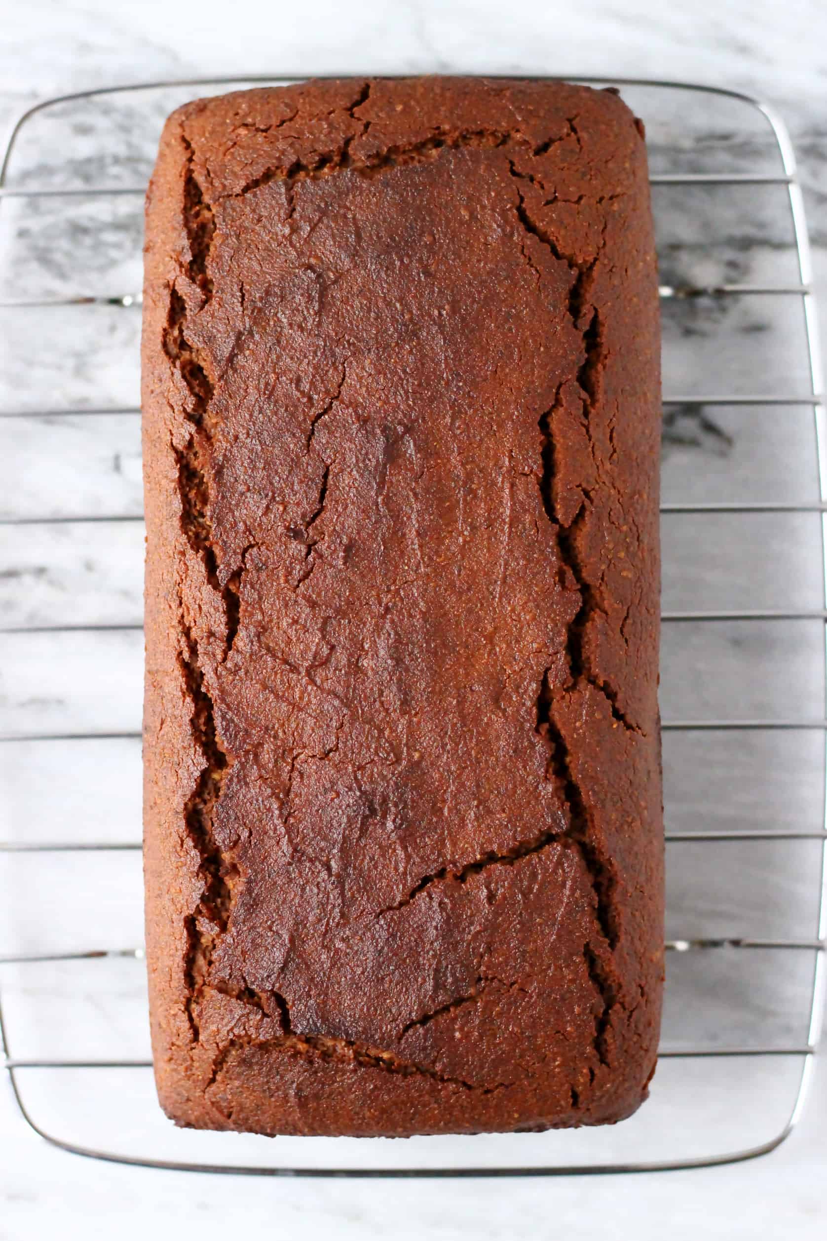 A gluten-free vegan gingerbread loaf cake on a wire rack