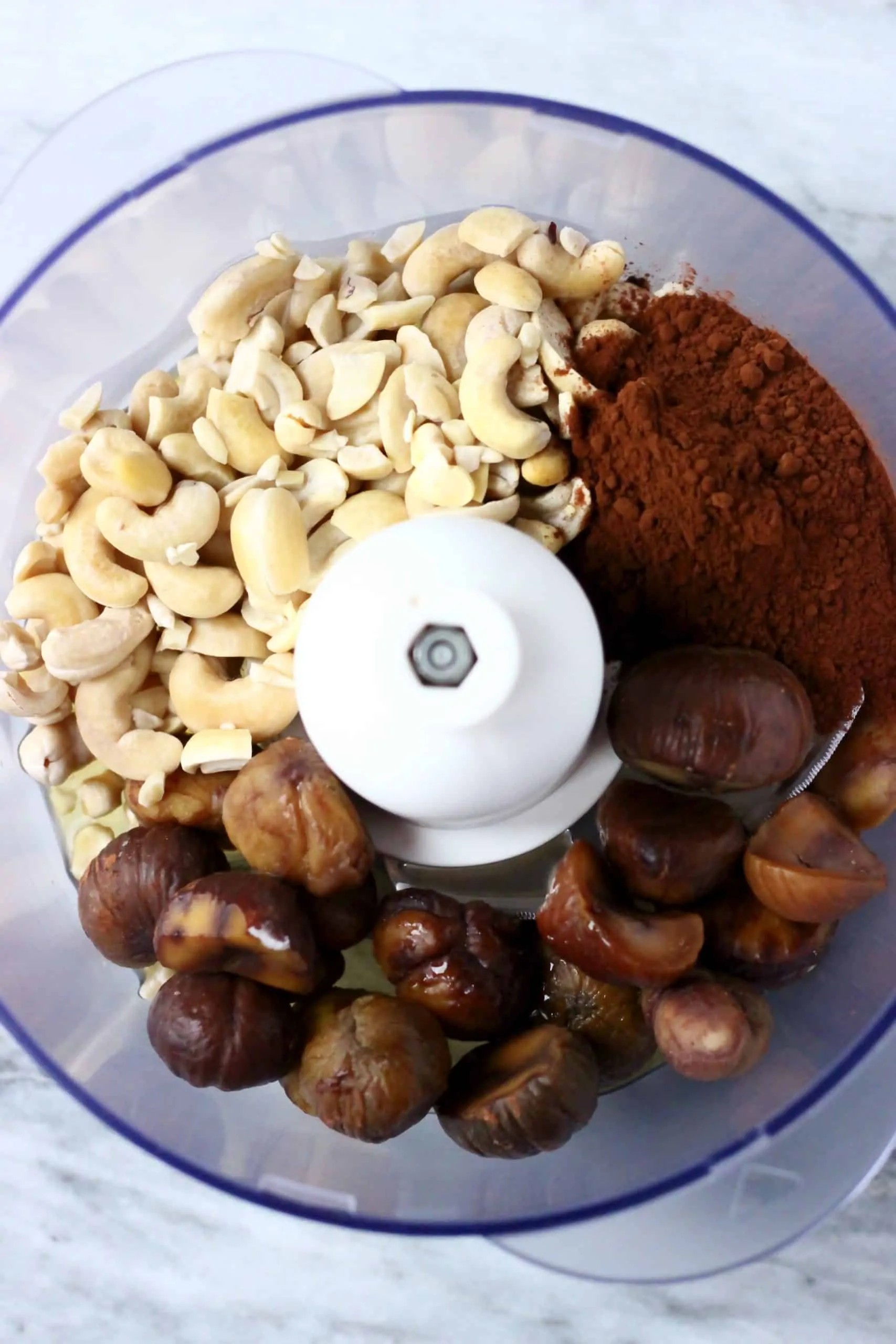 Cashews, cocoa powder and chestnuts in a food processor