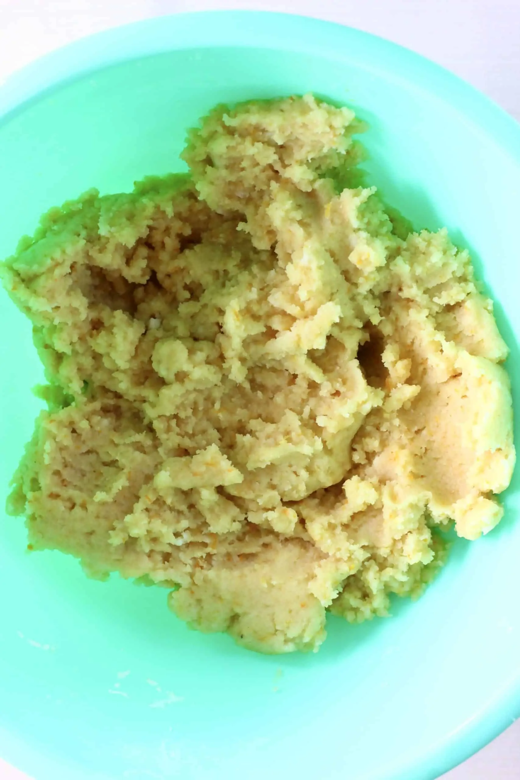 Raw gluten-free vegan orange cookie dough in a mixing bowl