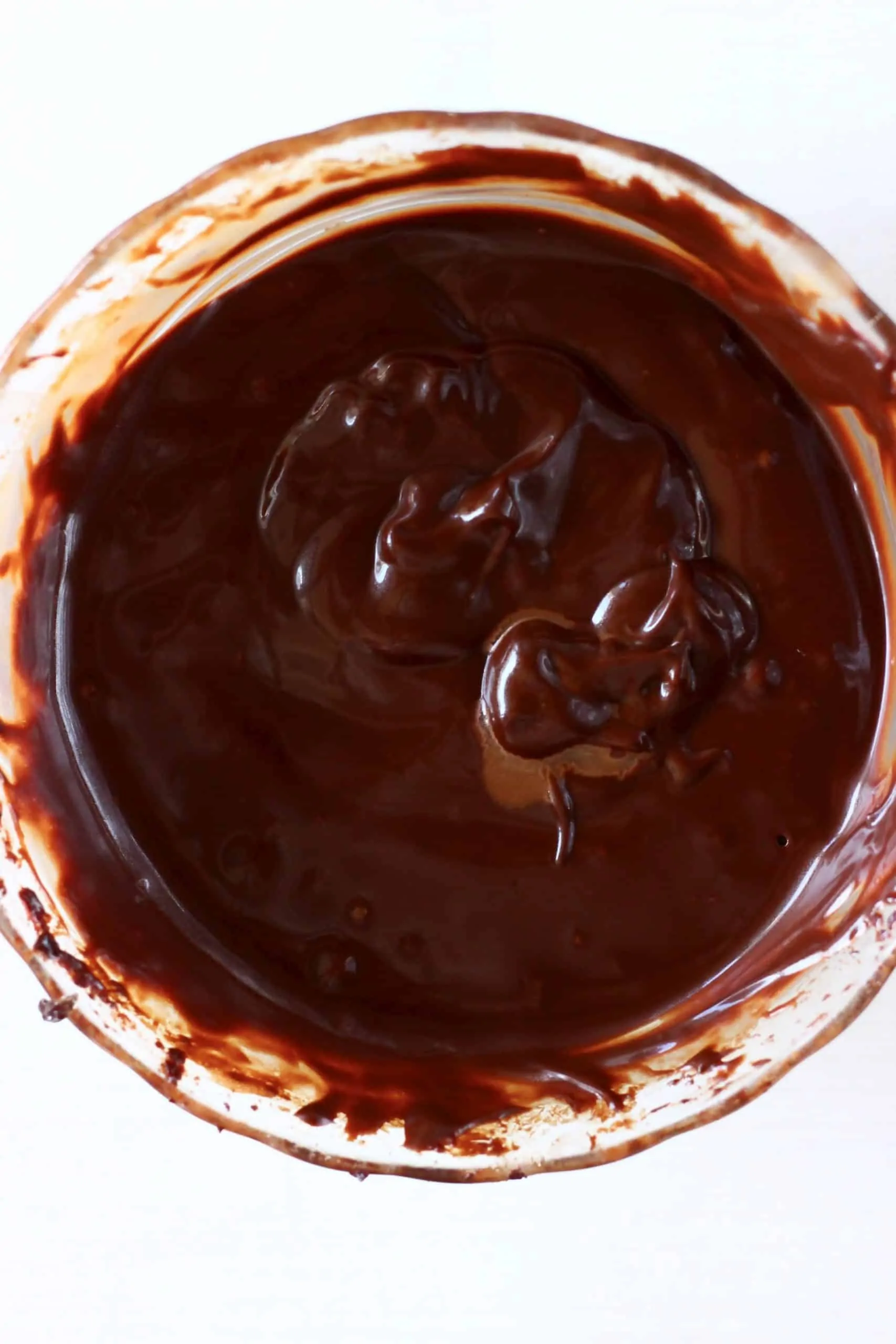 Melted dark chocolate in a glass bowl