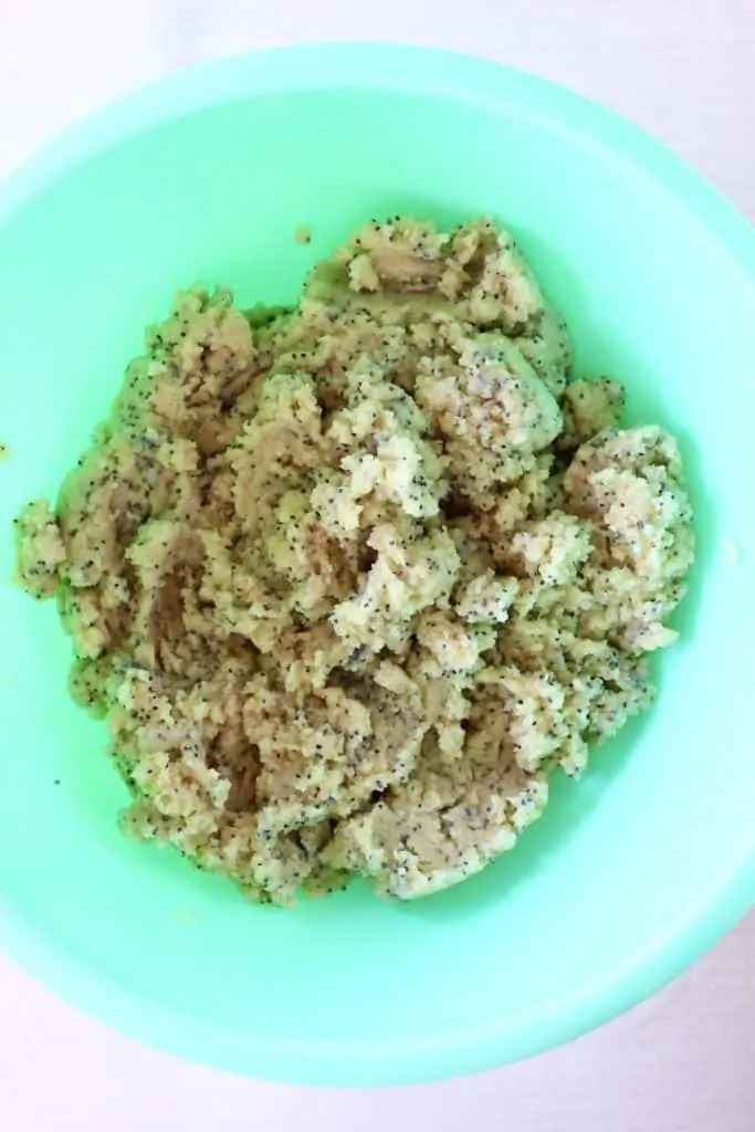 Raw lemon poppy seed cookie dough in a mixing bowl 