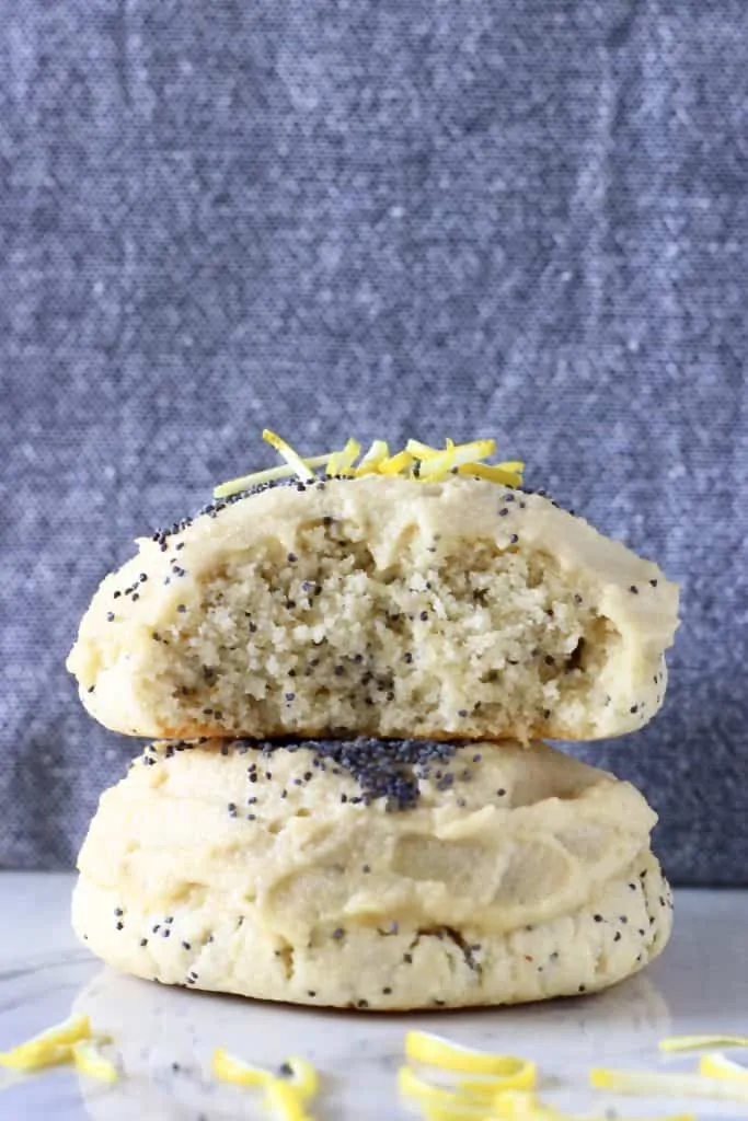 Two lemon poppy seed cookies stacked on top of each other with a bite taken out of one
