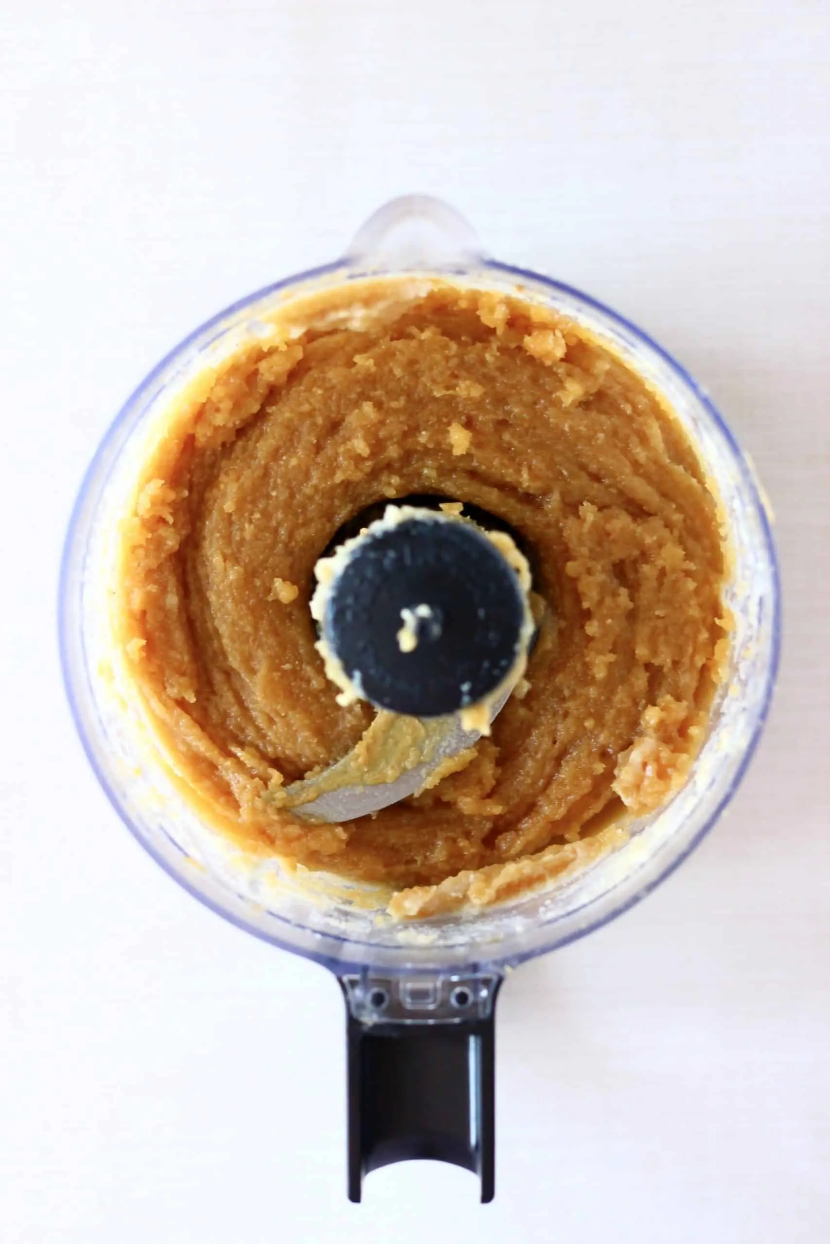 Blended peanut butter ball mixture in a food processor