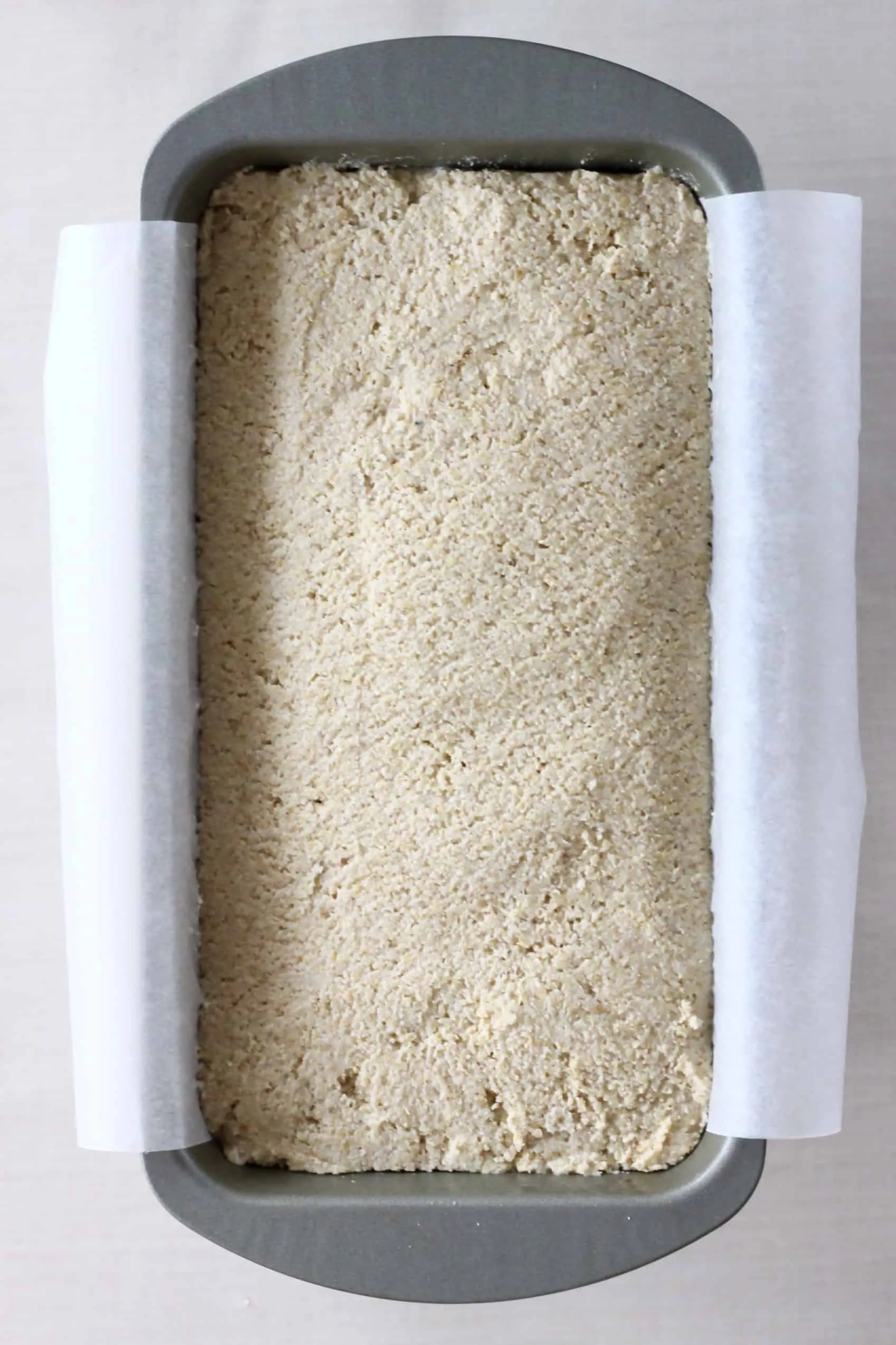 Oat flour bread dough in a loaf tin