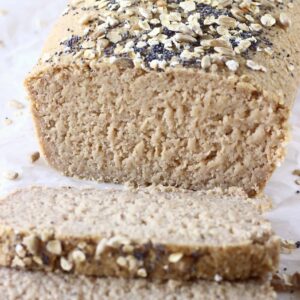 A loaf of oat flour bread with two slices