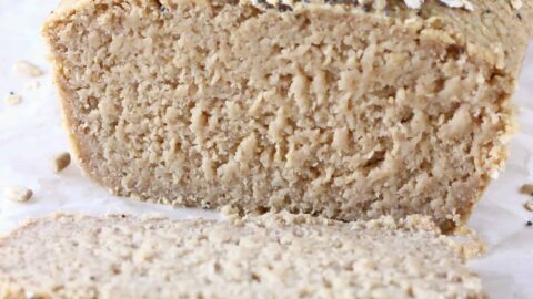 A loaf of oat flour bread with two slices