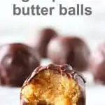 Chocolate-covered peanut butter balls with a bite taken out of one