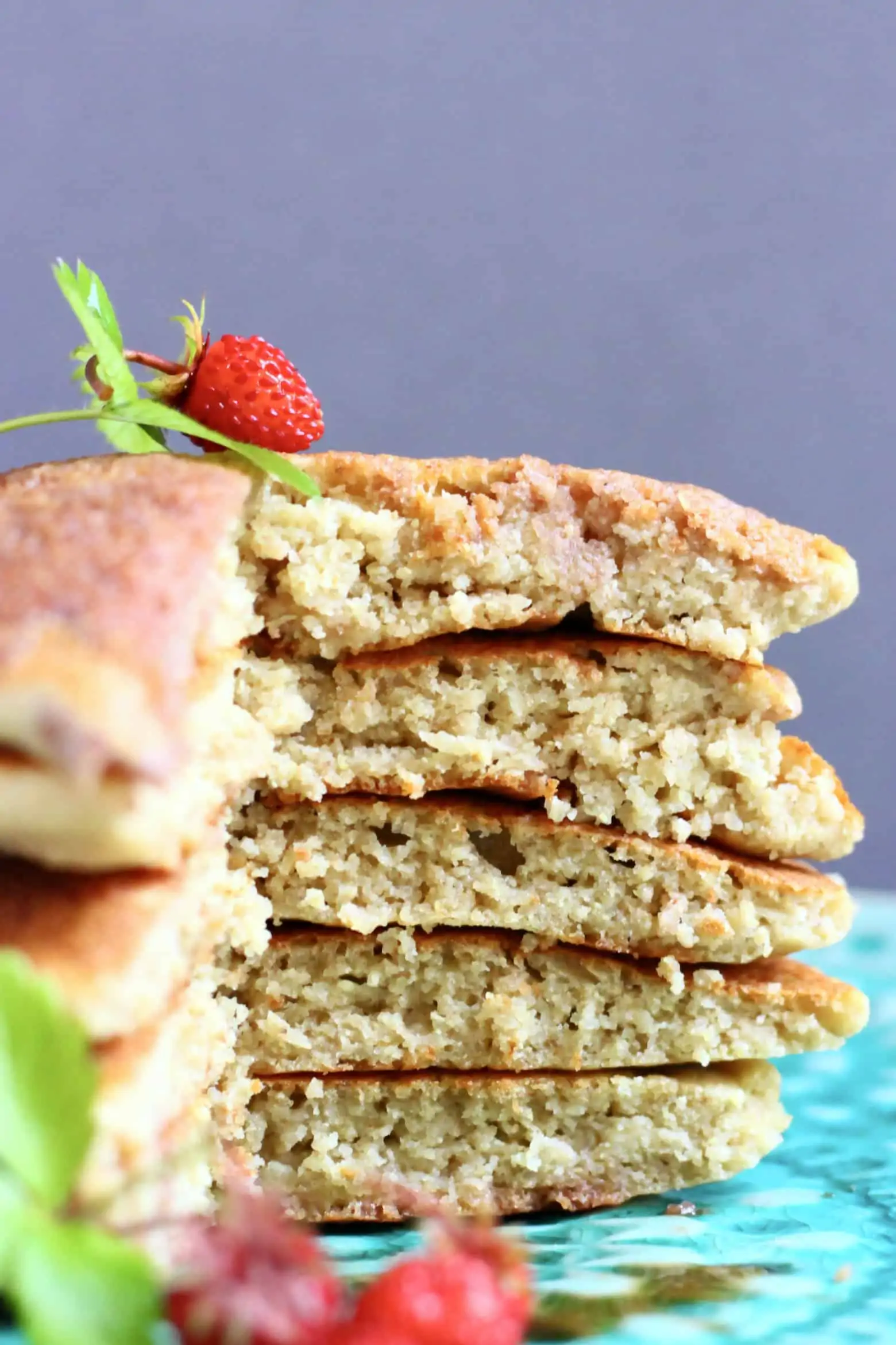 A sliced stack of five quinoa pancakes on a plate