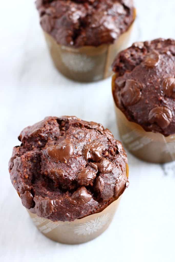 Three chocolate banana muffins in muffin cases