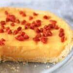 Gluten-free vegan lemon tart topped with goji berries in a pie dish