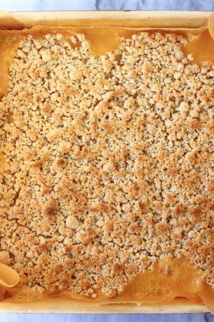 Baked lemon crumble bars in a square baking tin