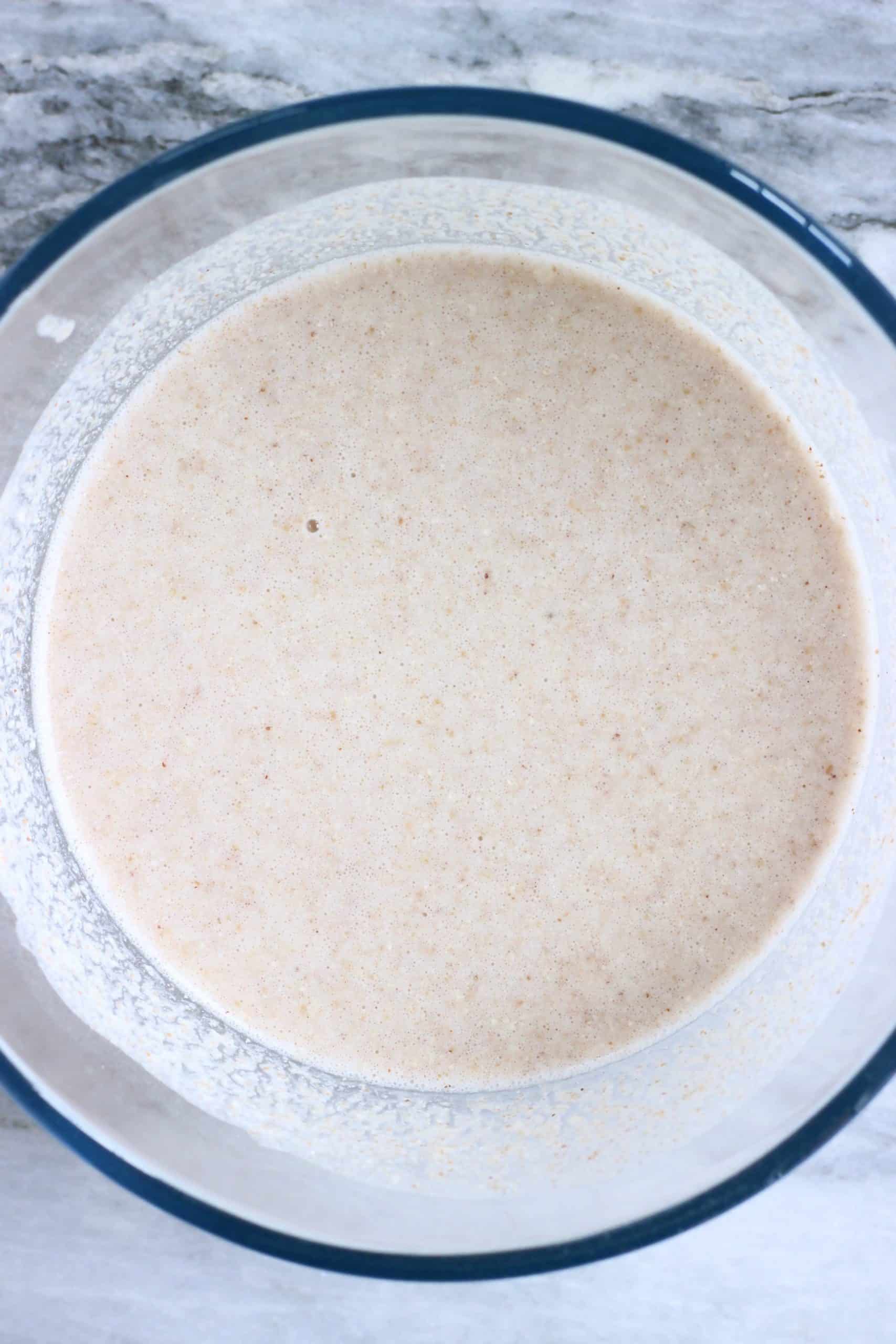 Raw buckwheat crepe batter in a glass bowl