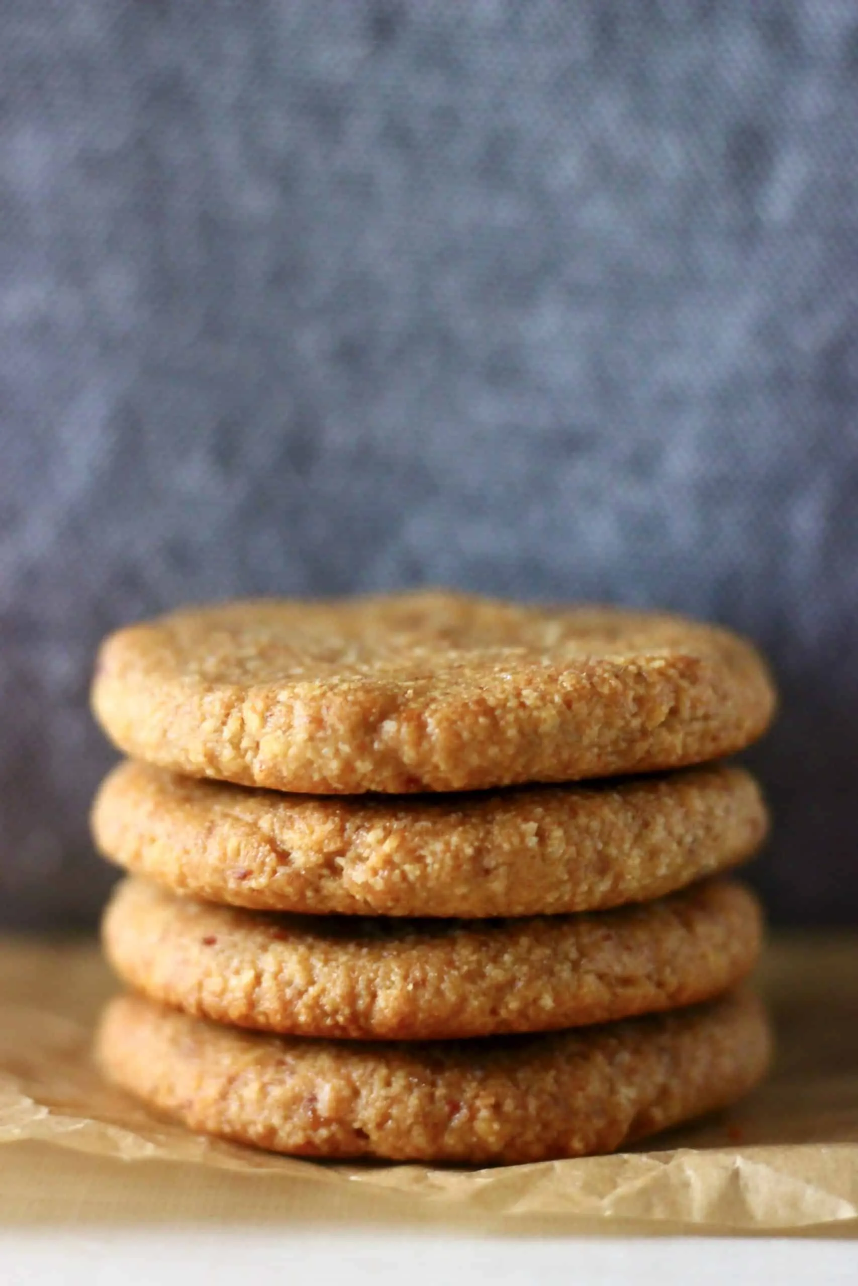 Four almond butter cookies stacked on top of each other