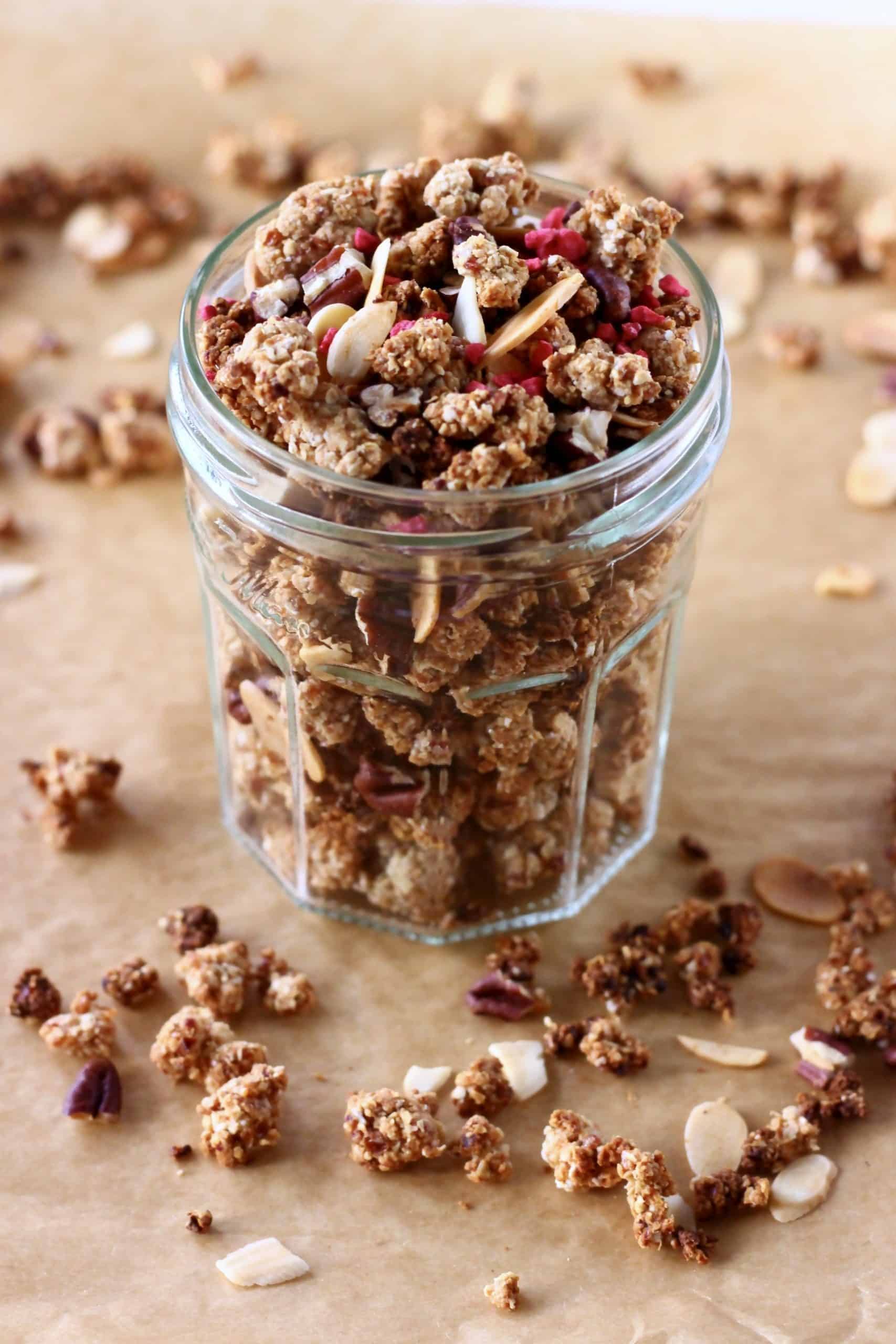 Clusters of gluten-free vegan granola with nuts in a glass jar