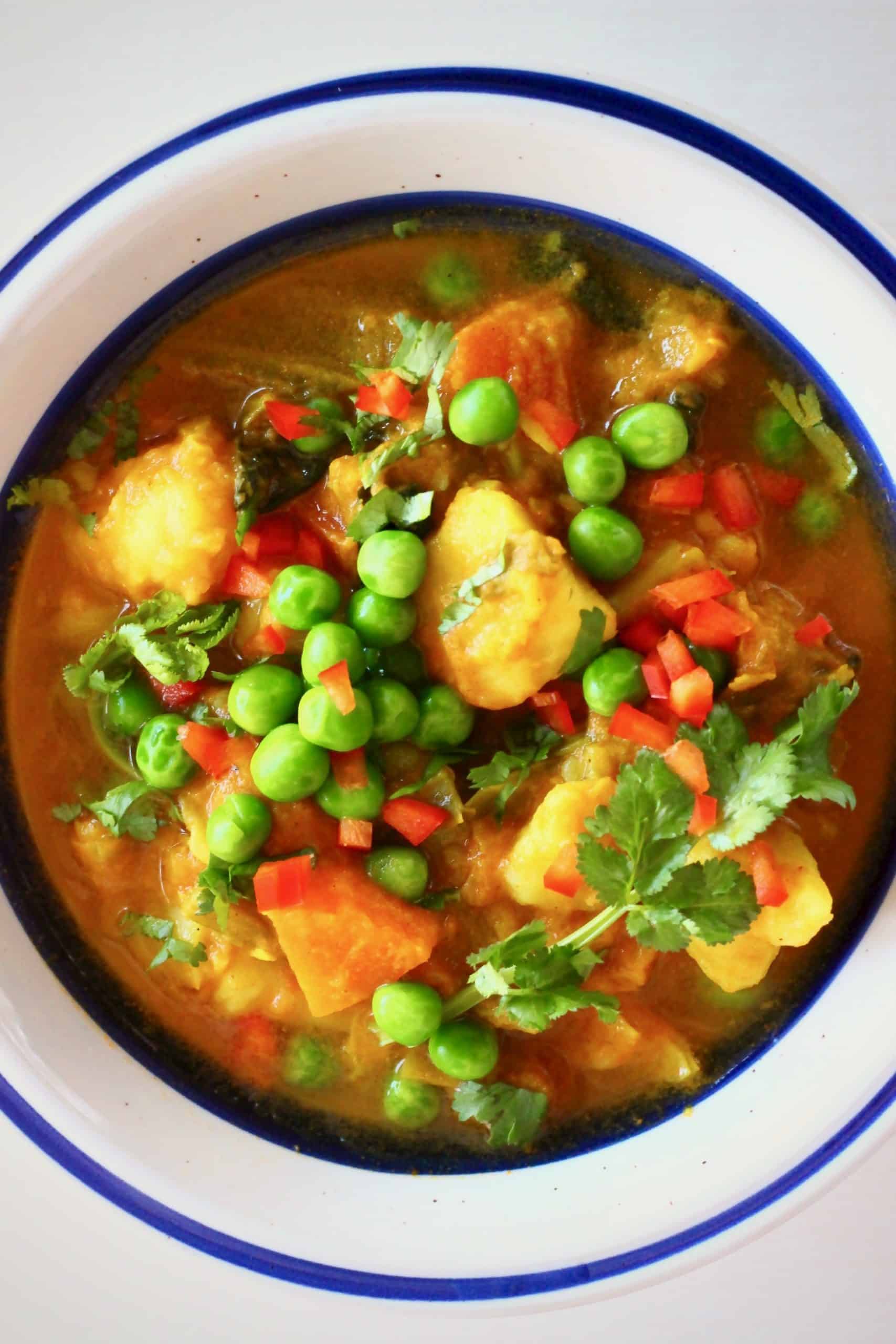 Potato pea curry in a white bowl