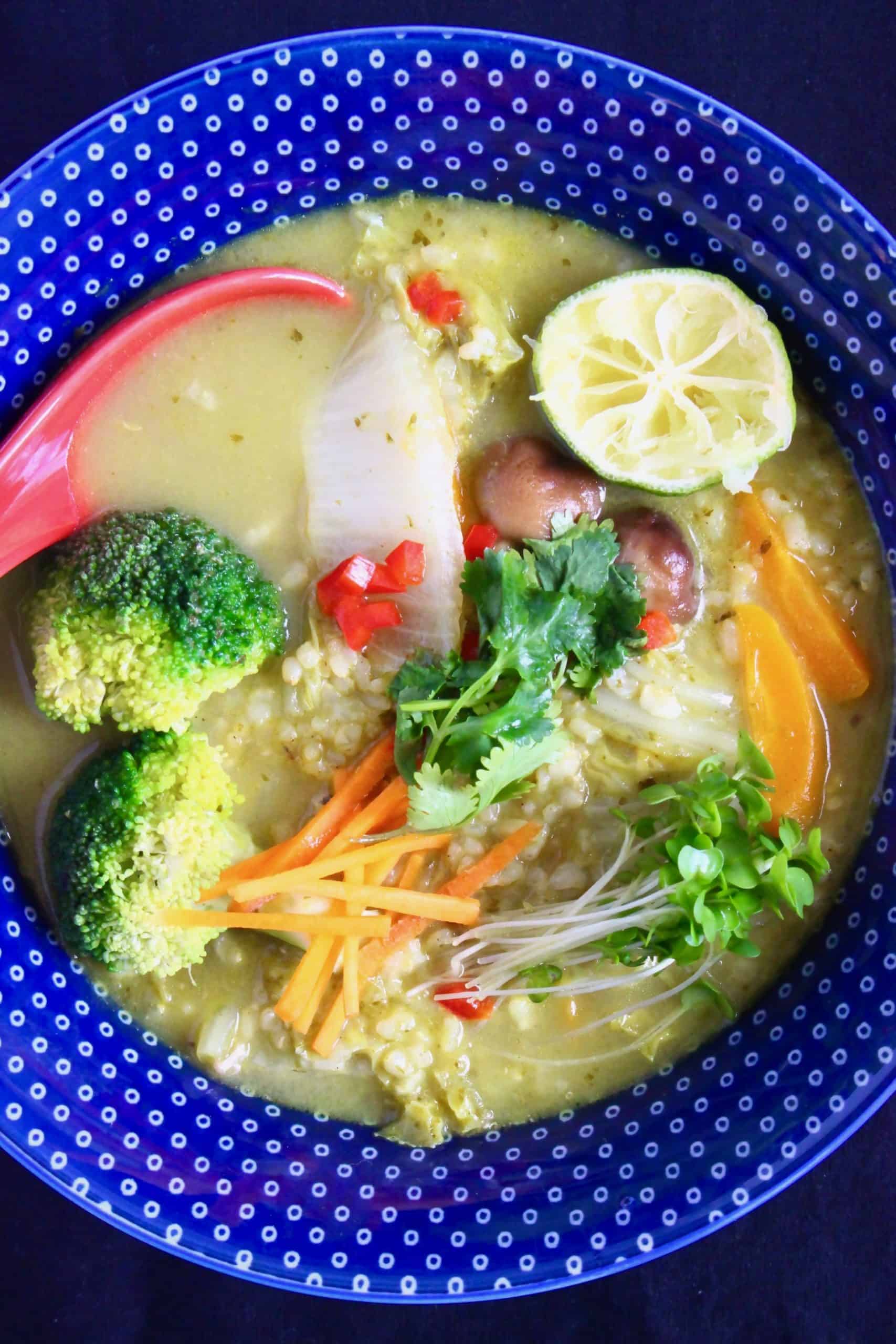 Thai green curry rice soup in a blue bowl