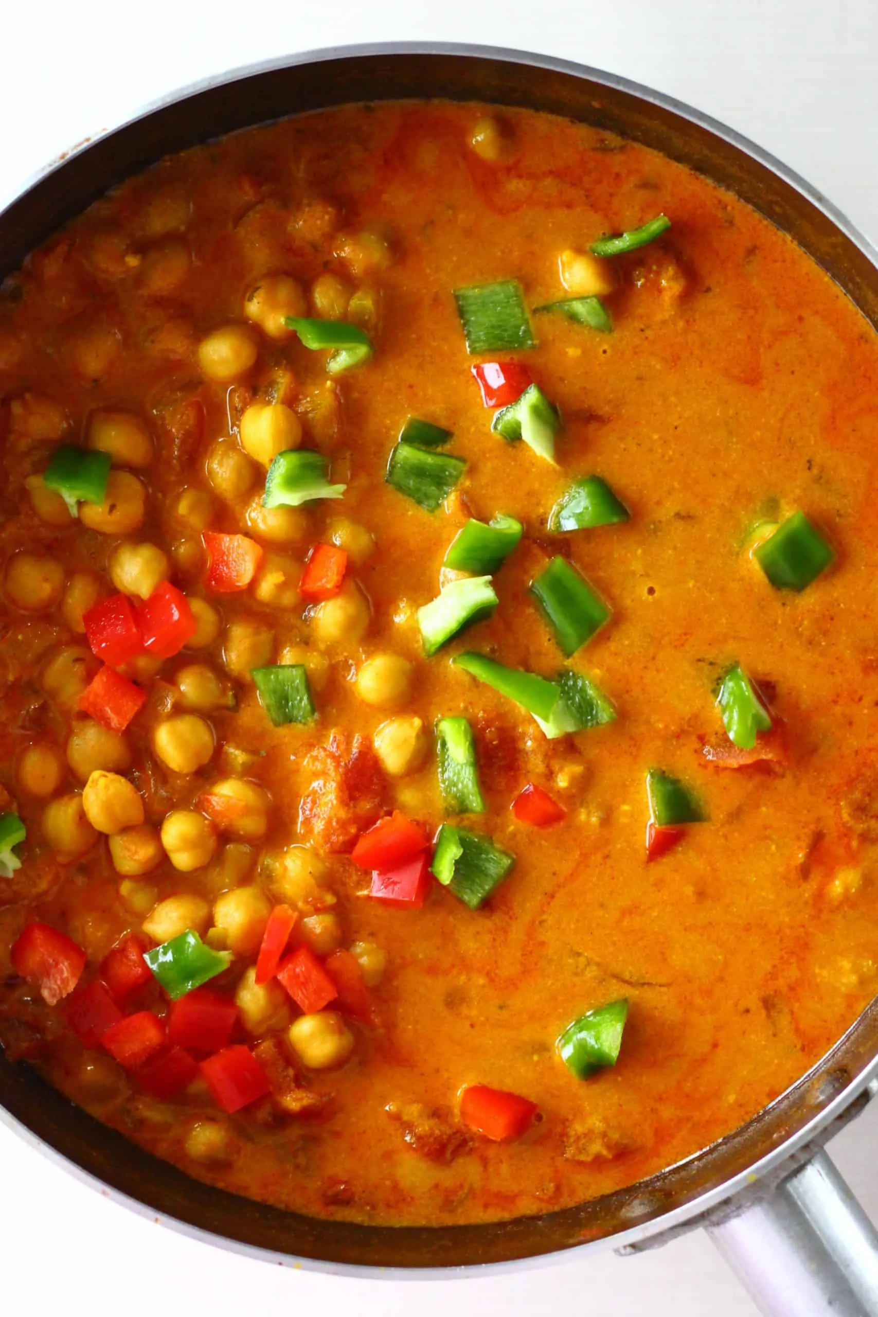 Chickpea tikka masala in a saucepan with peppers