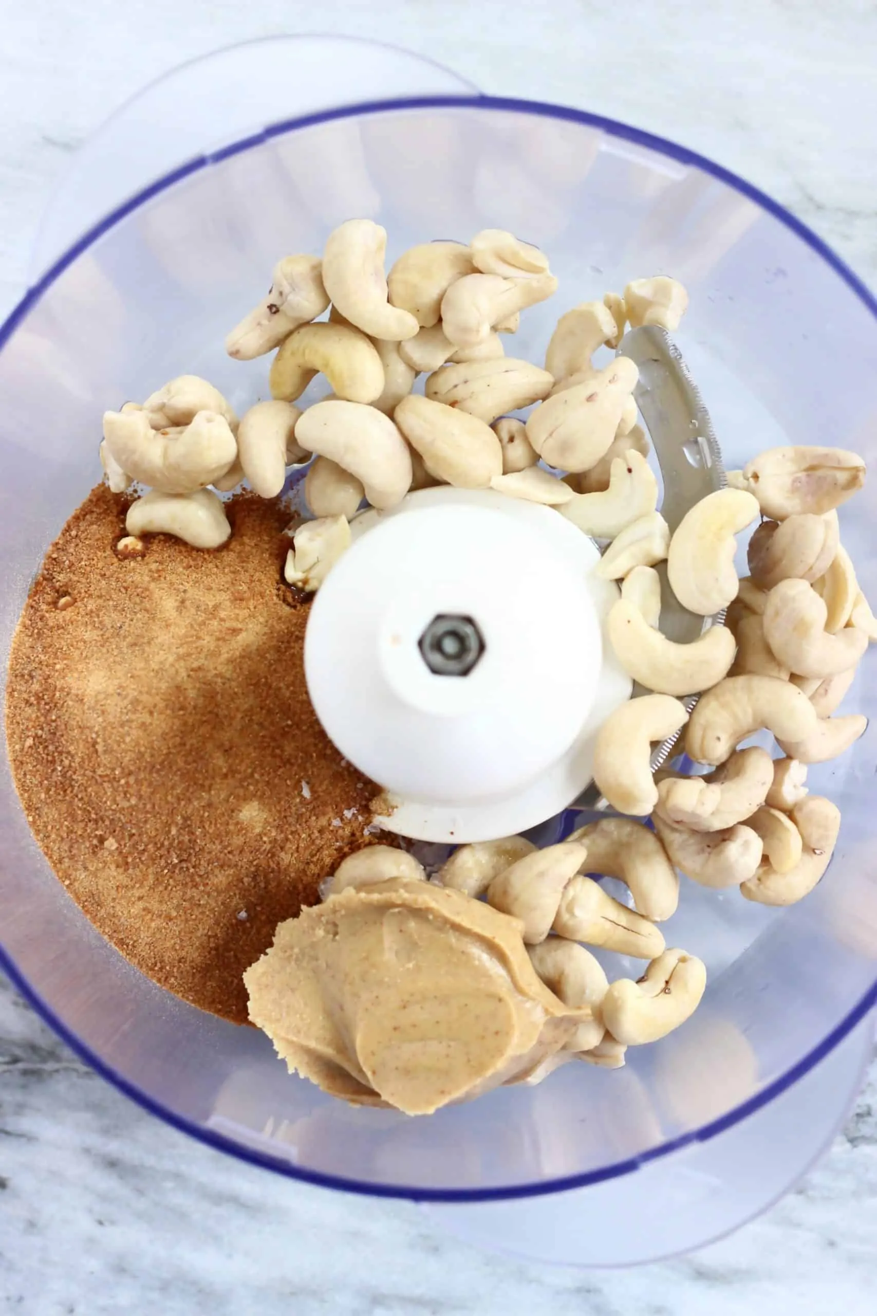 Cashew nuts, almond butter and coconut sugar in a food processor