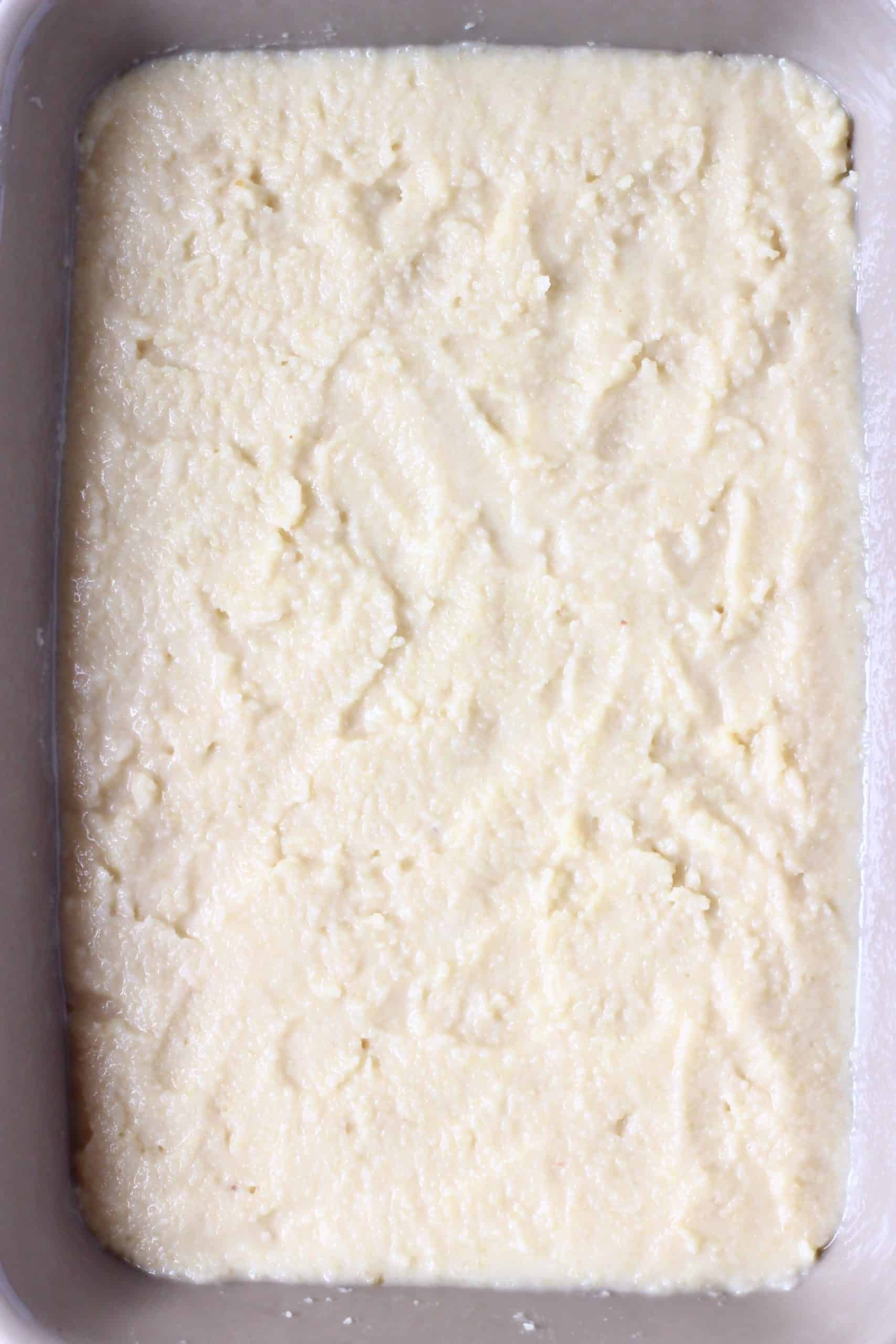 Raw vegan lemon pudding in a grey rectangular baking dish