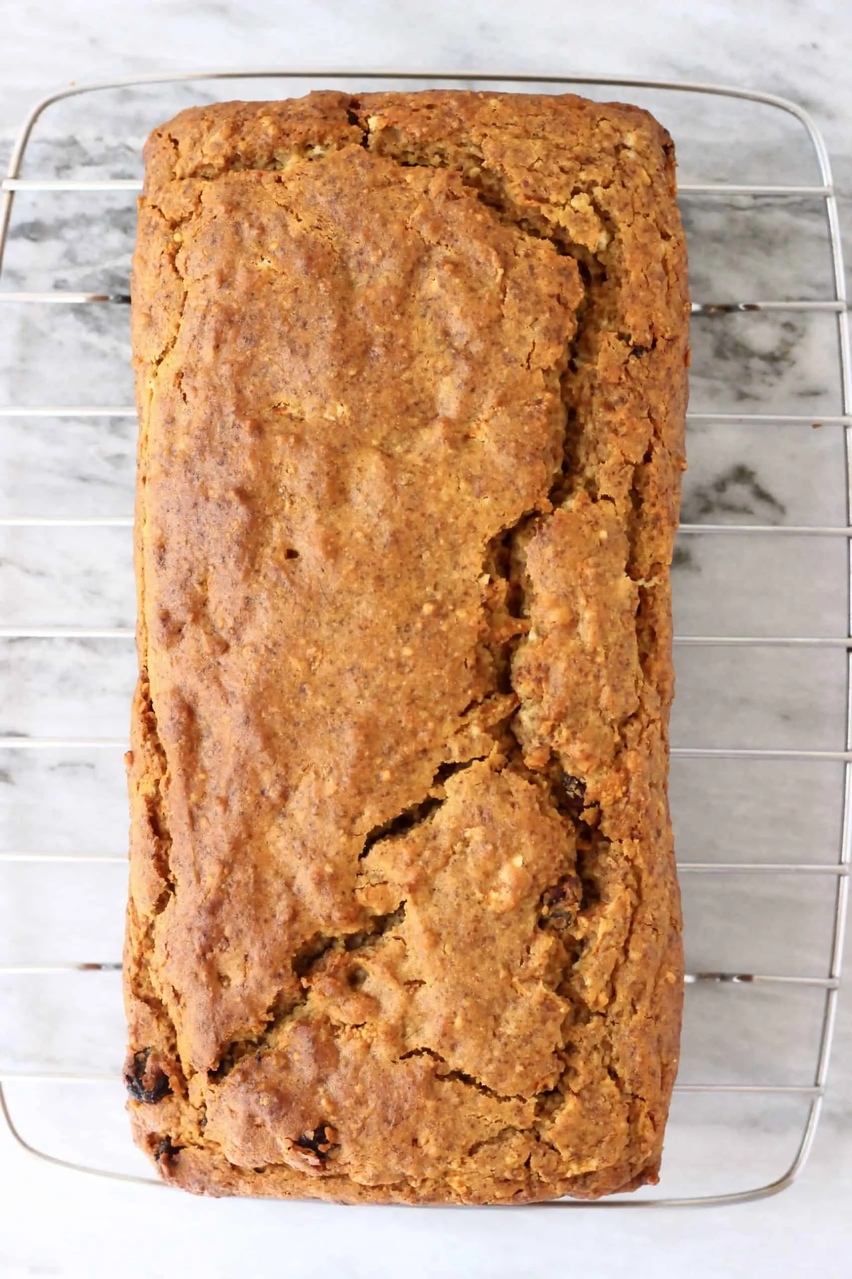 A loaf of vegan carrot bread on a wire rack