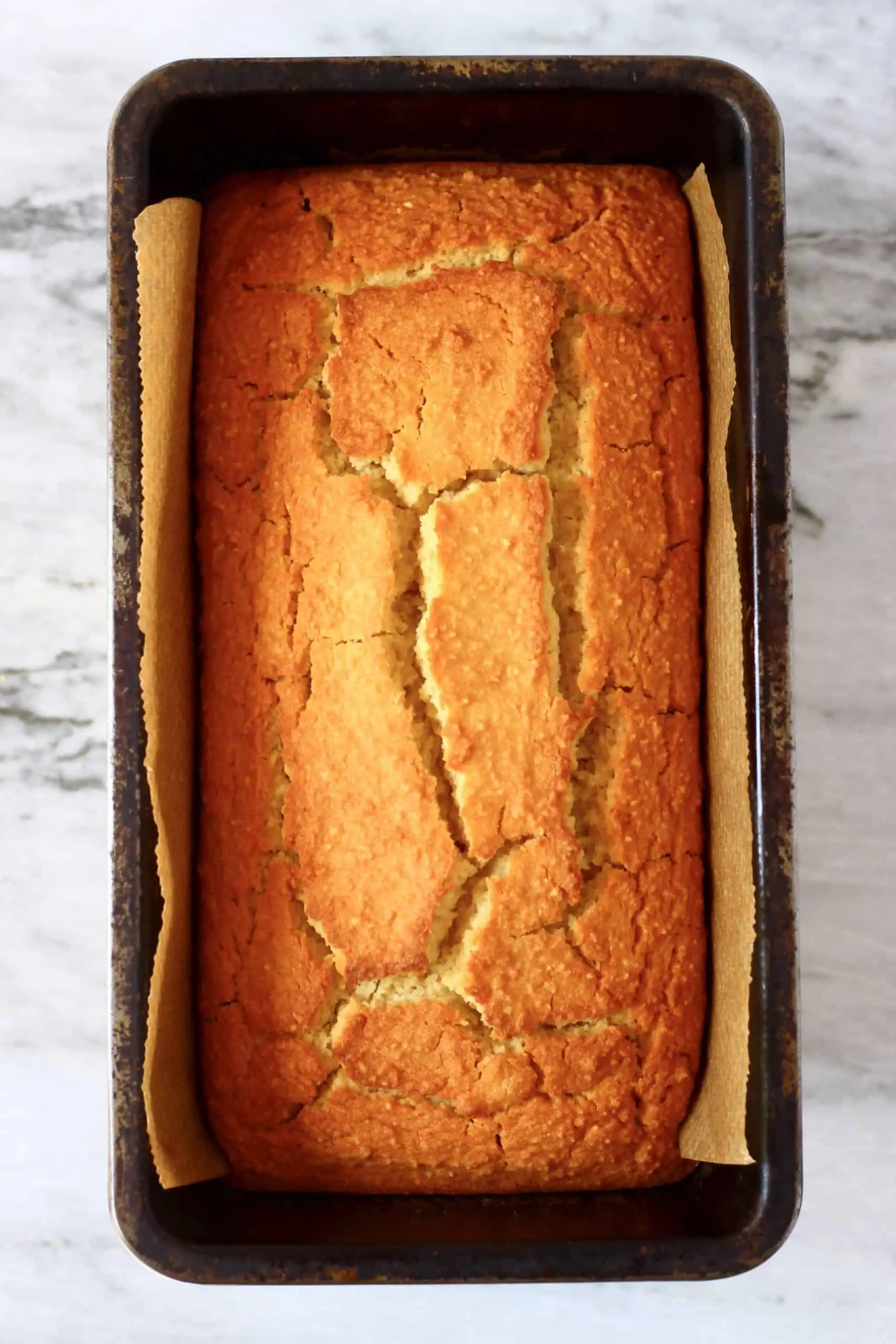 A loaf of vegan orange bread in a loaf tin