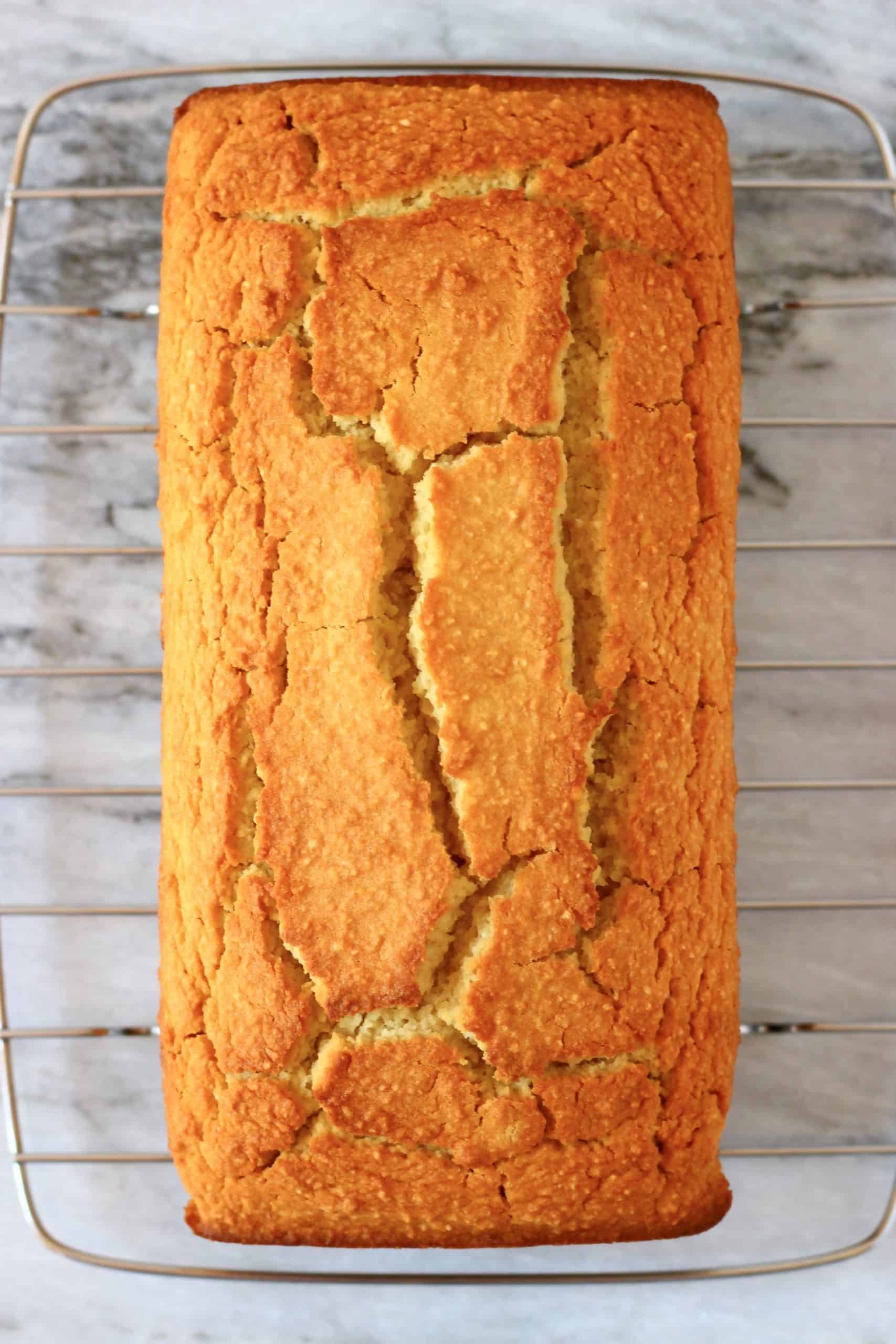A loaf of vegan orange bread on a wire rack