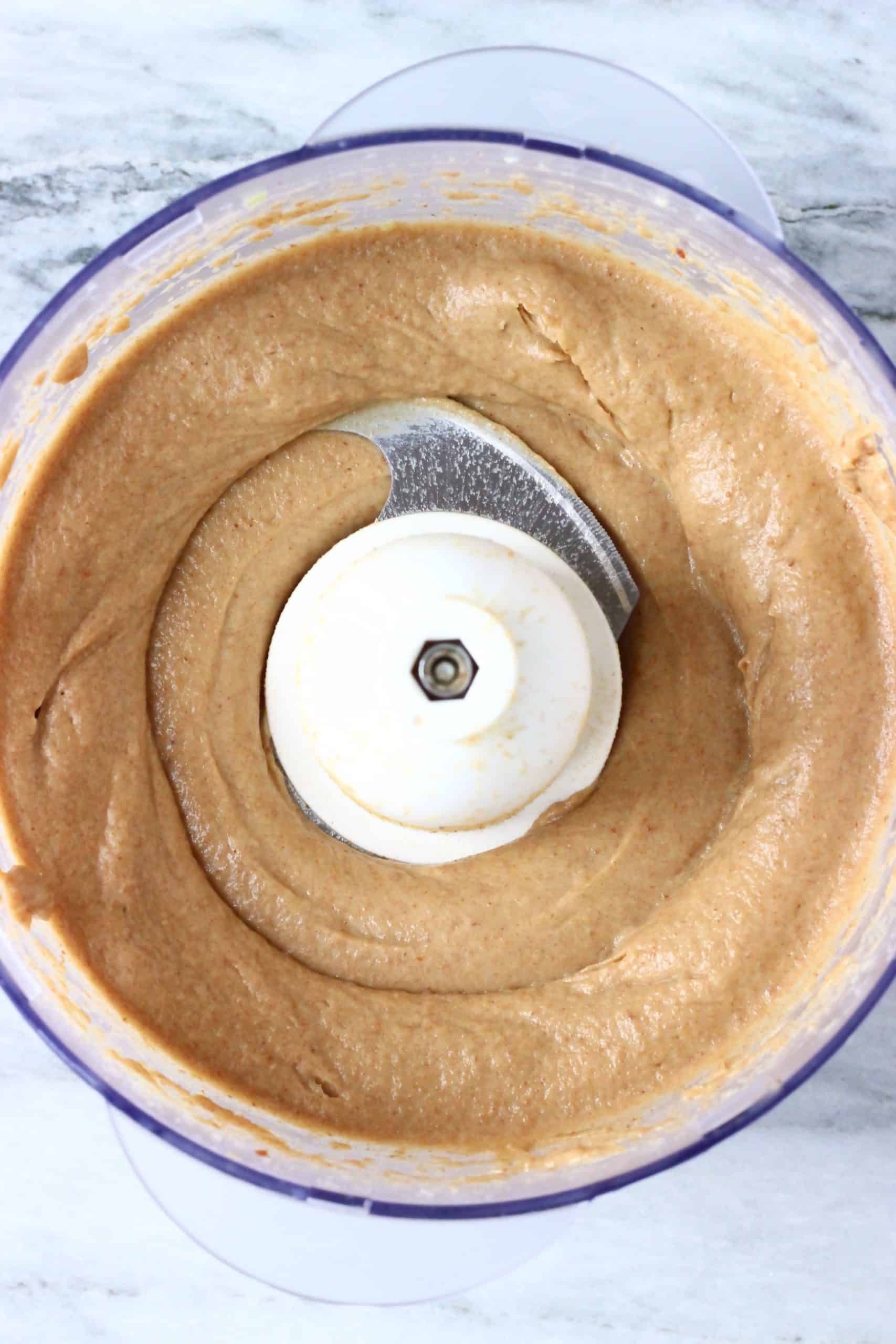 Blended avocado, dates, almond butter and almond milk in a food processor