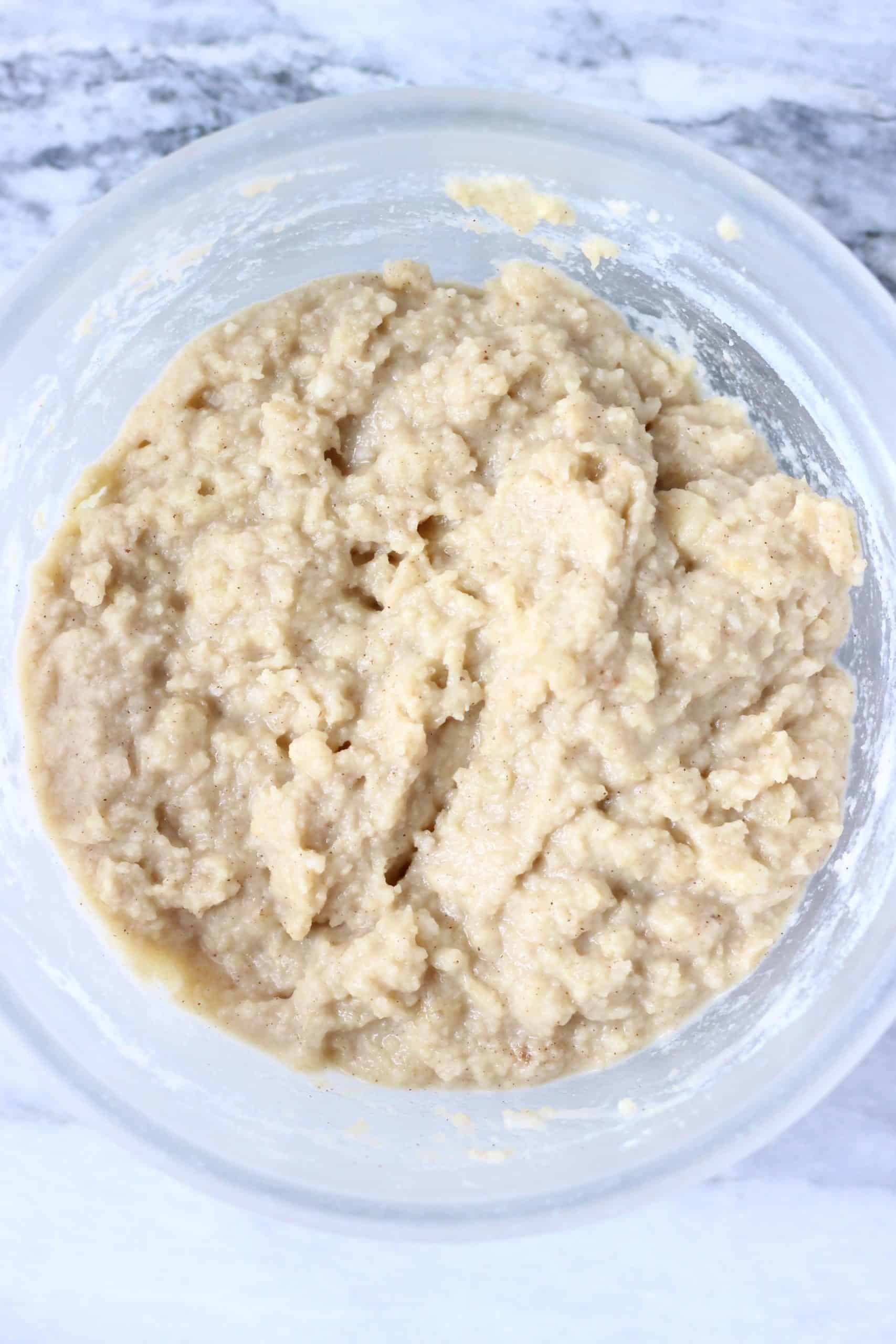 Raw gluten-free vegan banana muffin batter in a glass bowl