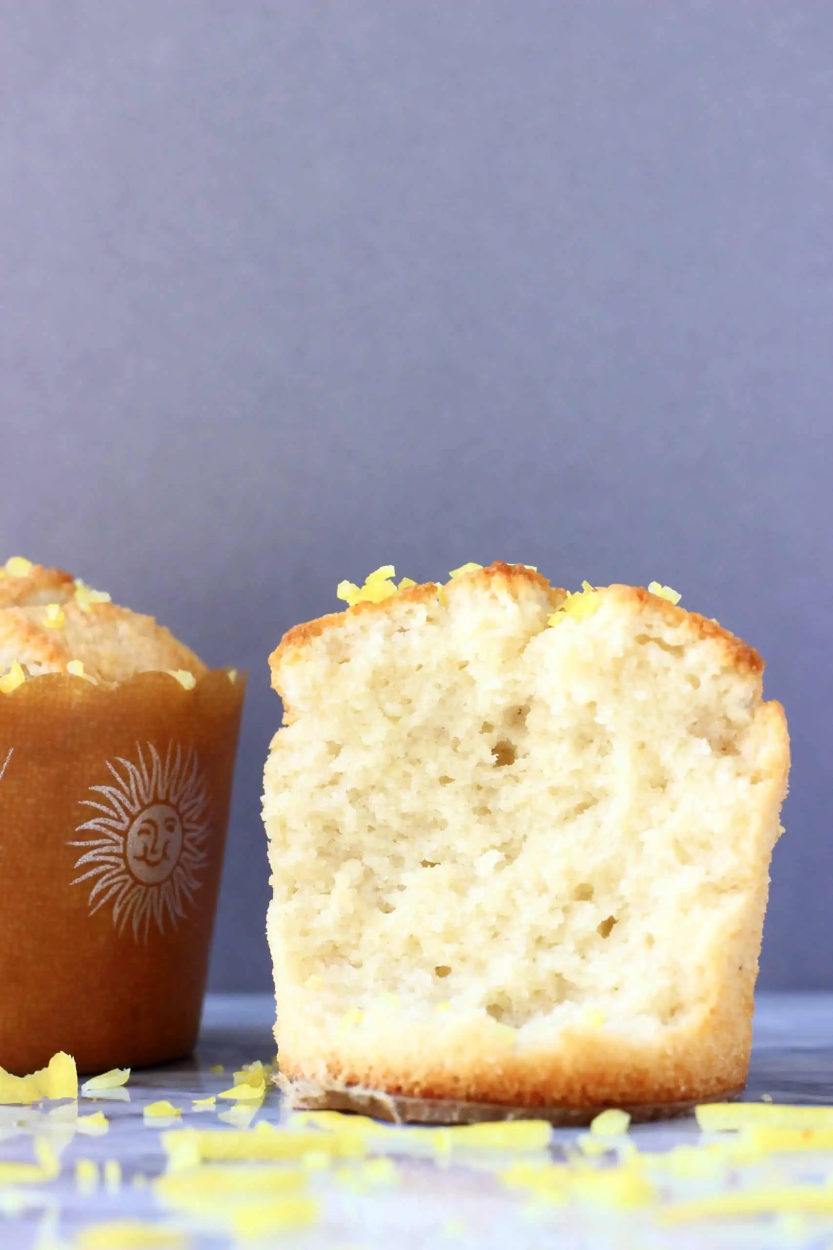Two gluten-free vegan lemon muffins with one cut in half