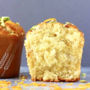 Two gluten-free vegan orange muffins, one cut in half