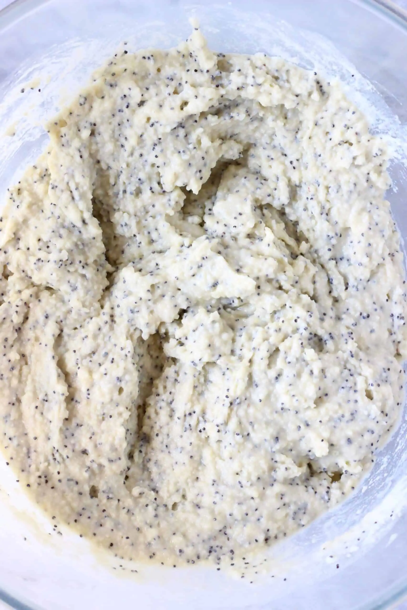 Raw gluten-free vegan lemon poppy seed bread batter in a glass bowl