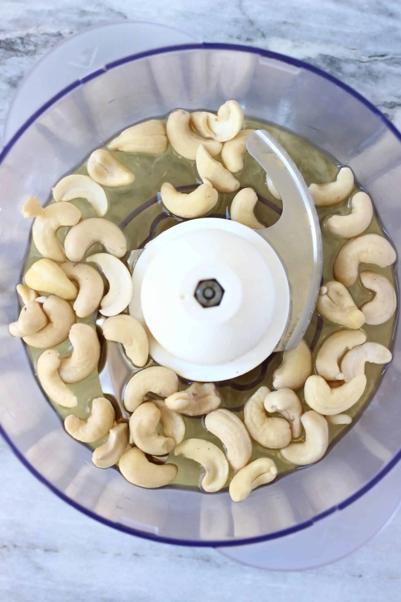 Cashew nuts, maple syrup and almond milk in a food processor