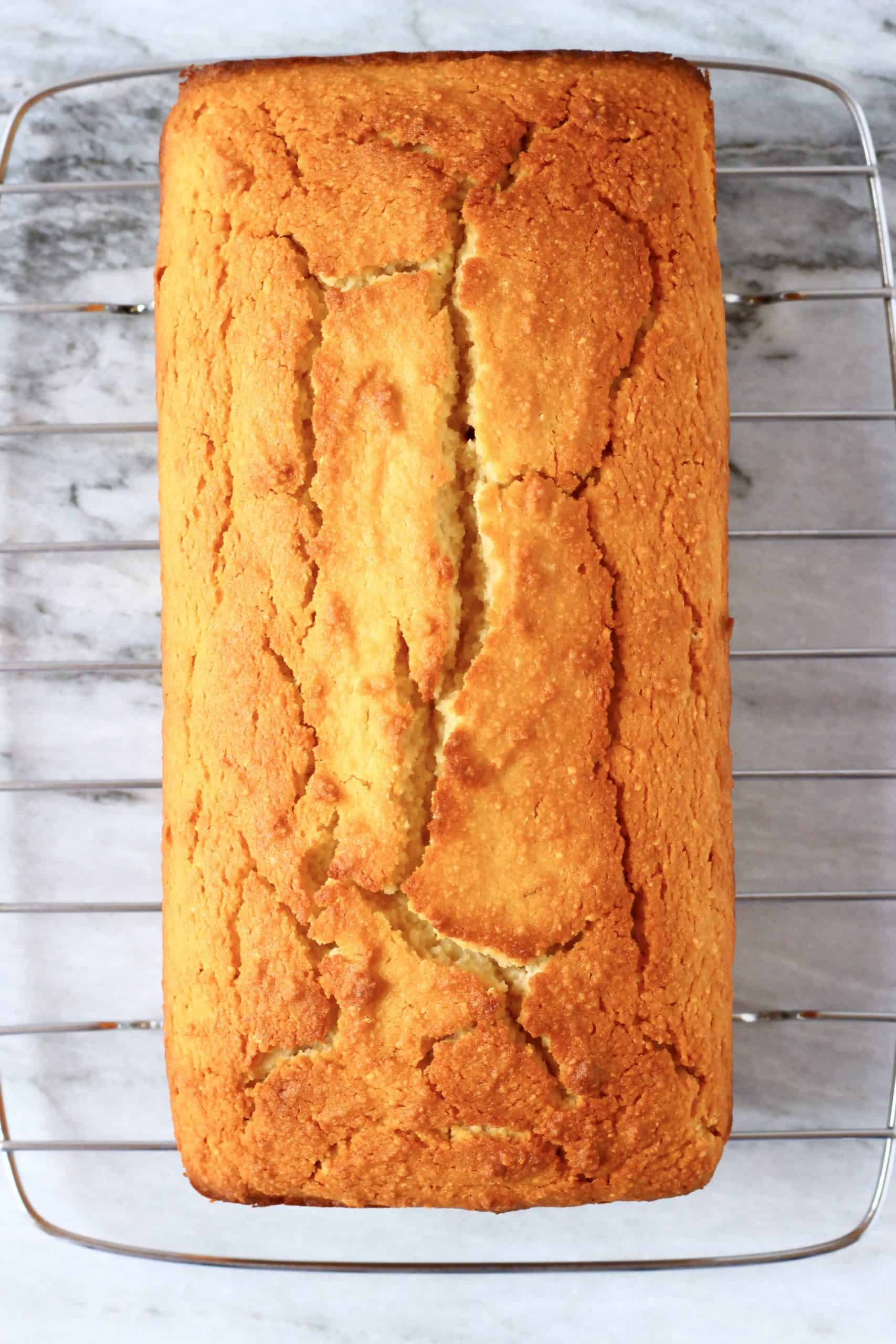 A loaf of gluten-free vegan lemon bread on a wire rack