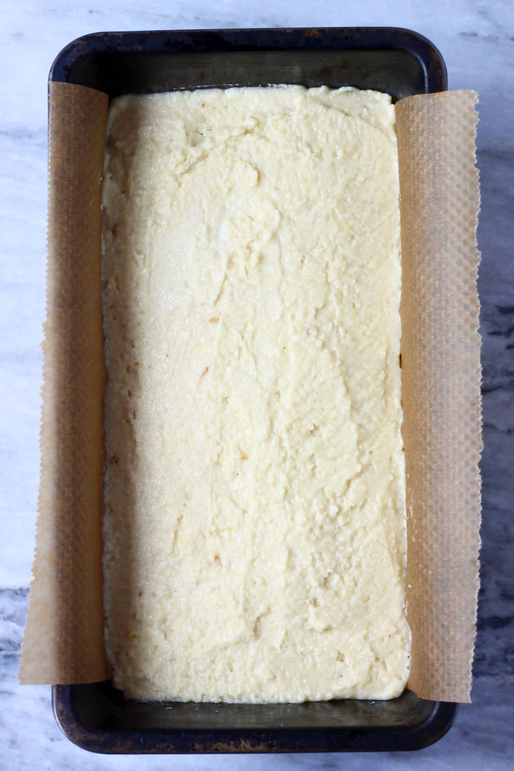 Raw gluten-free vegan orange pound cake batter in a loaf tin