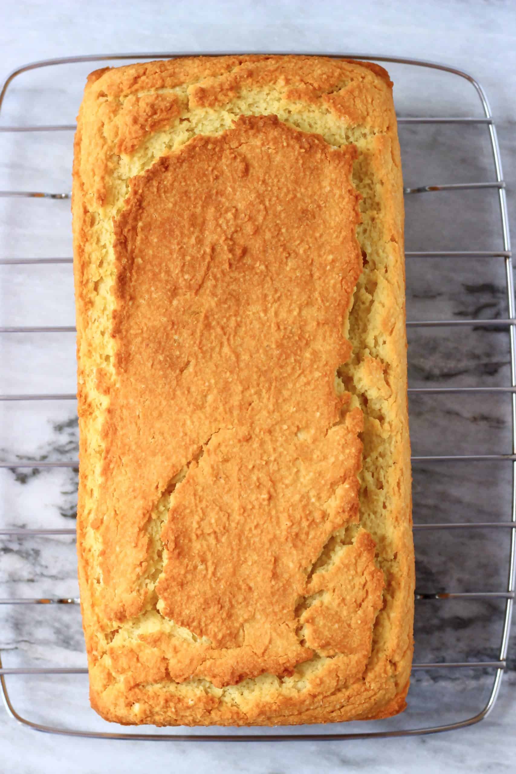 A loaf of gluten-free vegan orange pound cake on a wire rack