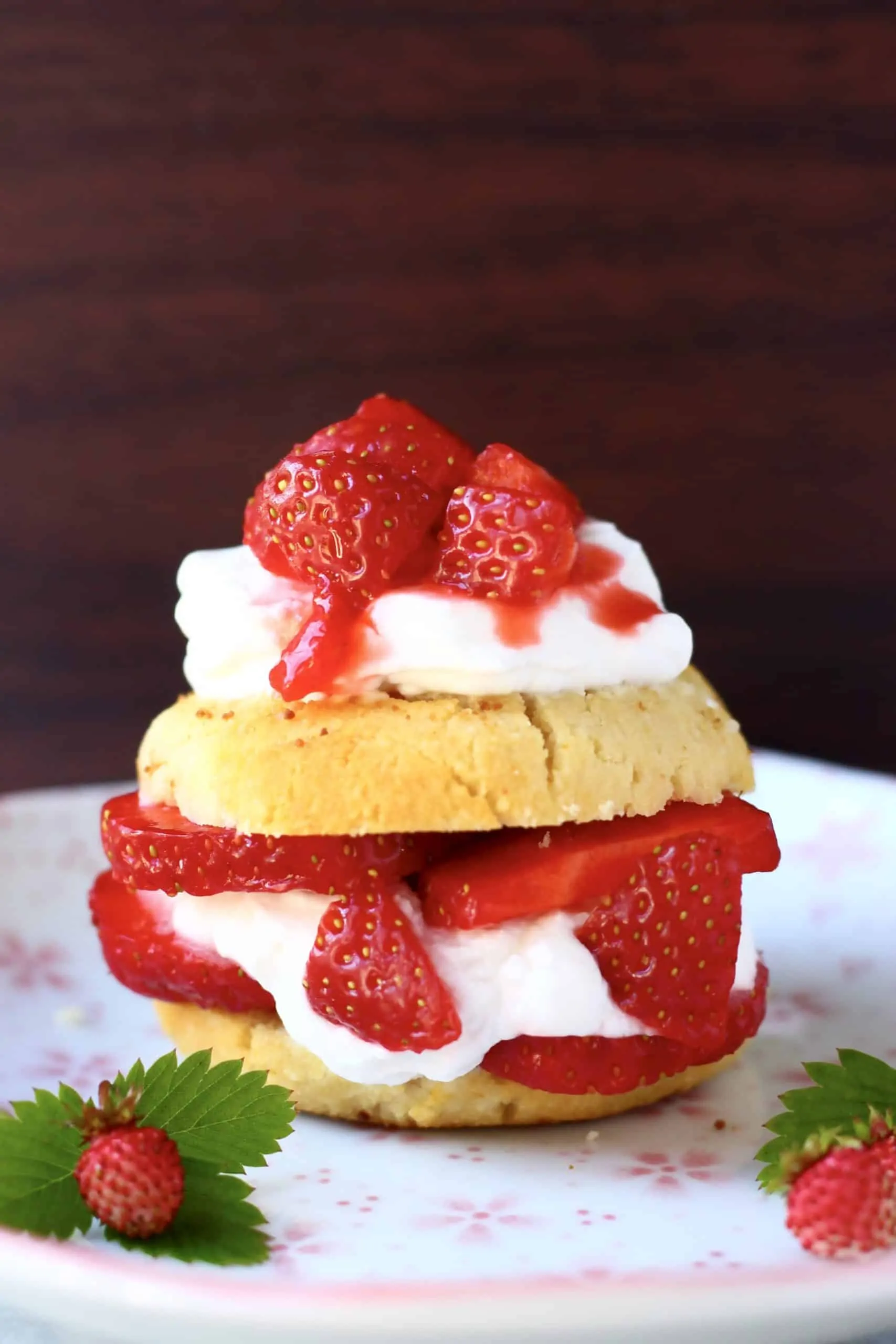 Vegan strawberry shortcake with cream and fresh strawberries on a plate