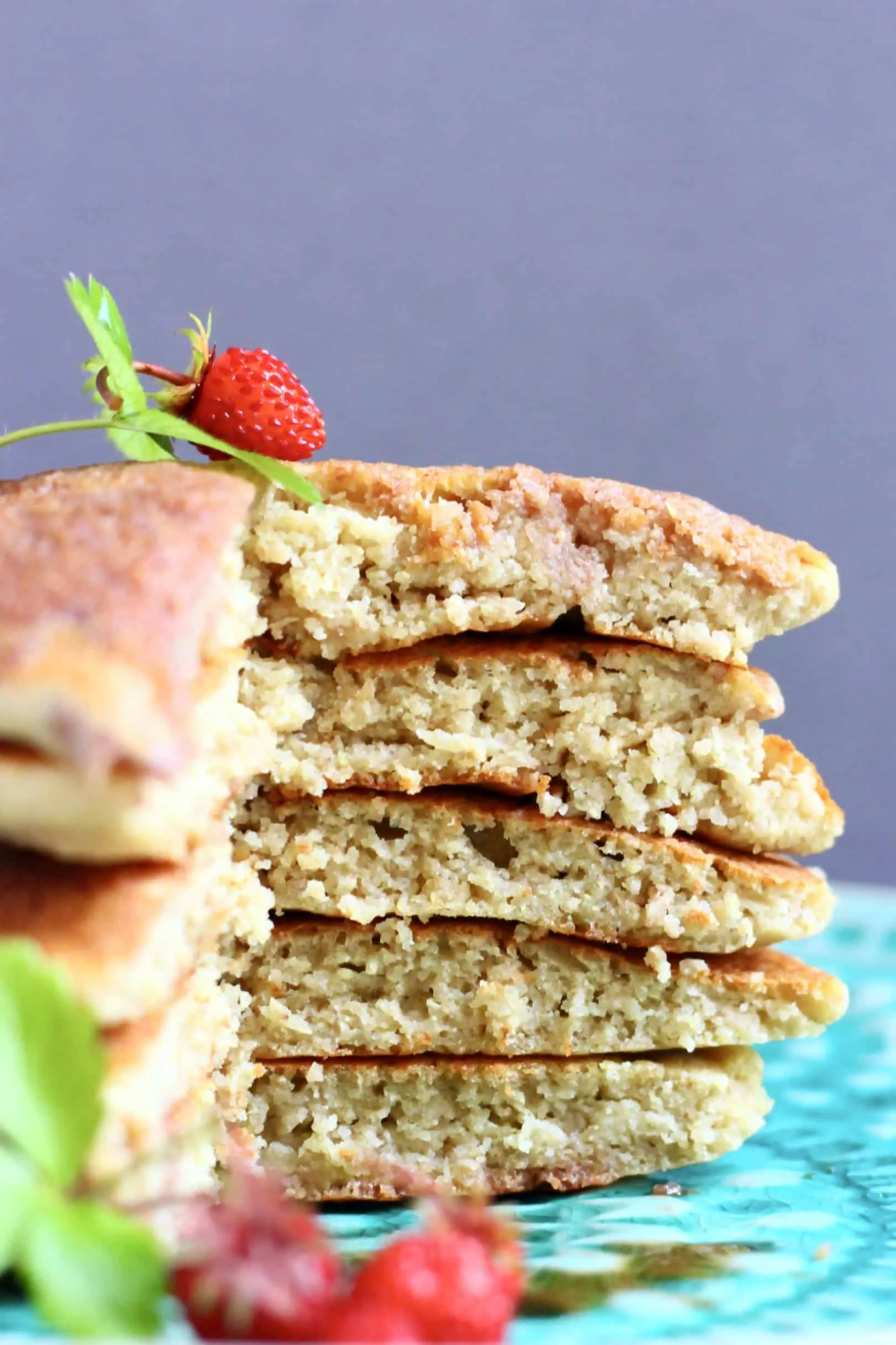 A sliced stack of five quinoa pancakes on a plate