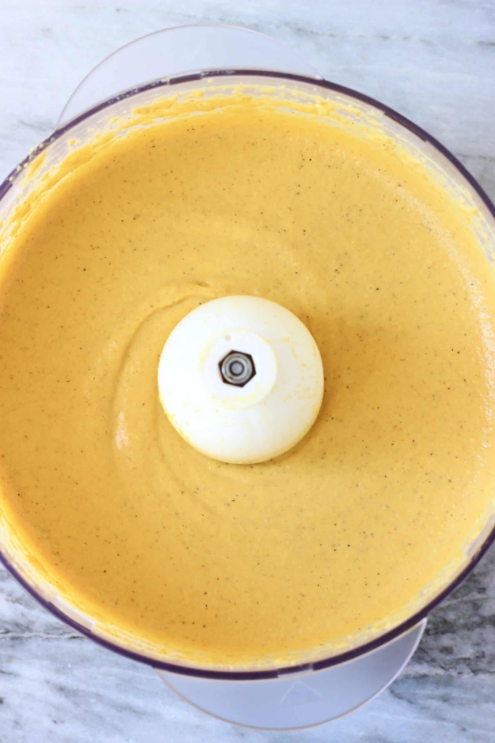 Vegan pumpkin cheesecake filling in a food processor