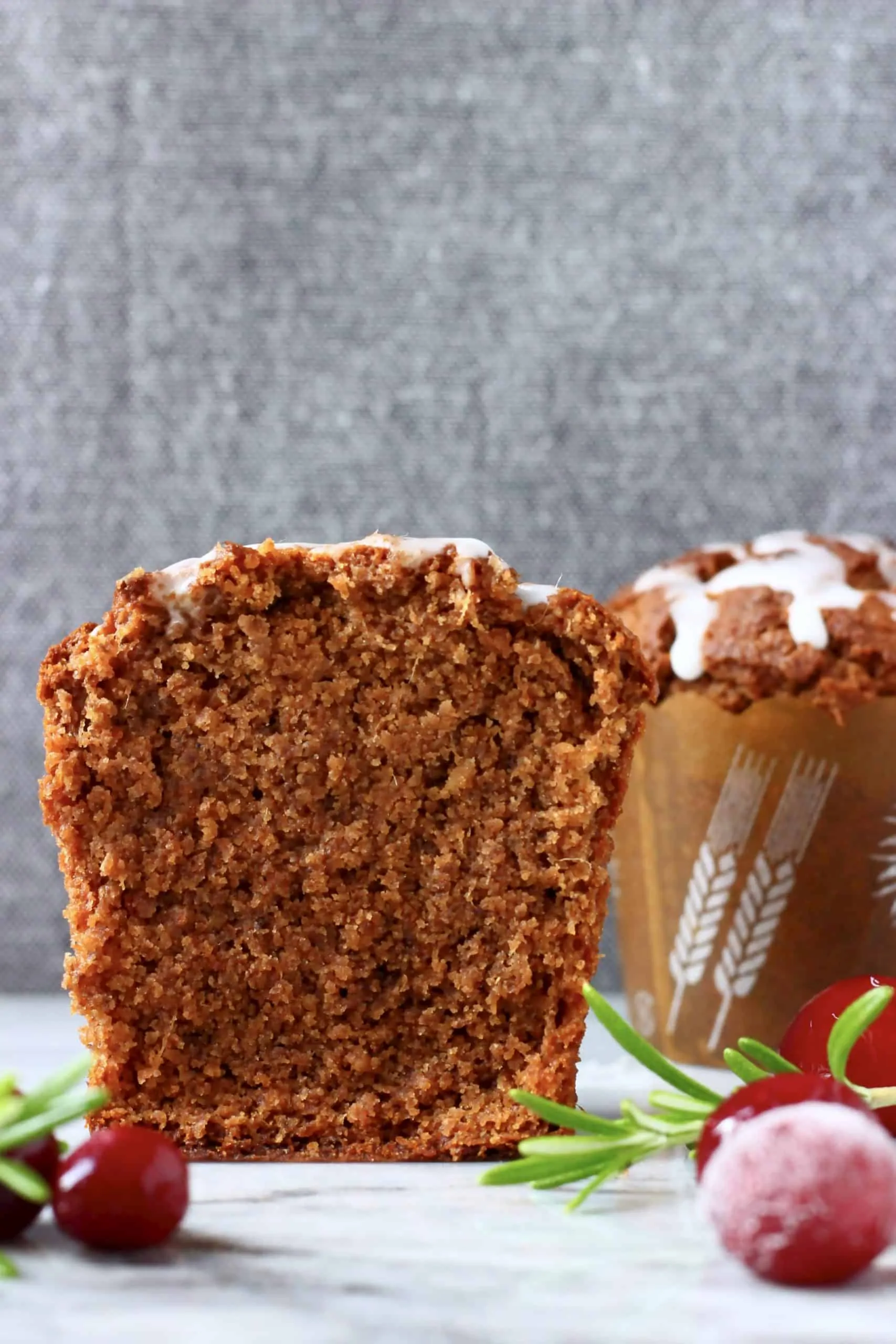 Two gluten-free vegan gingerbread muffins, one sliced in half
