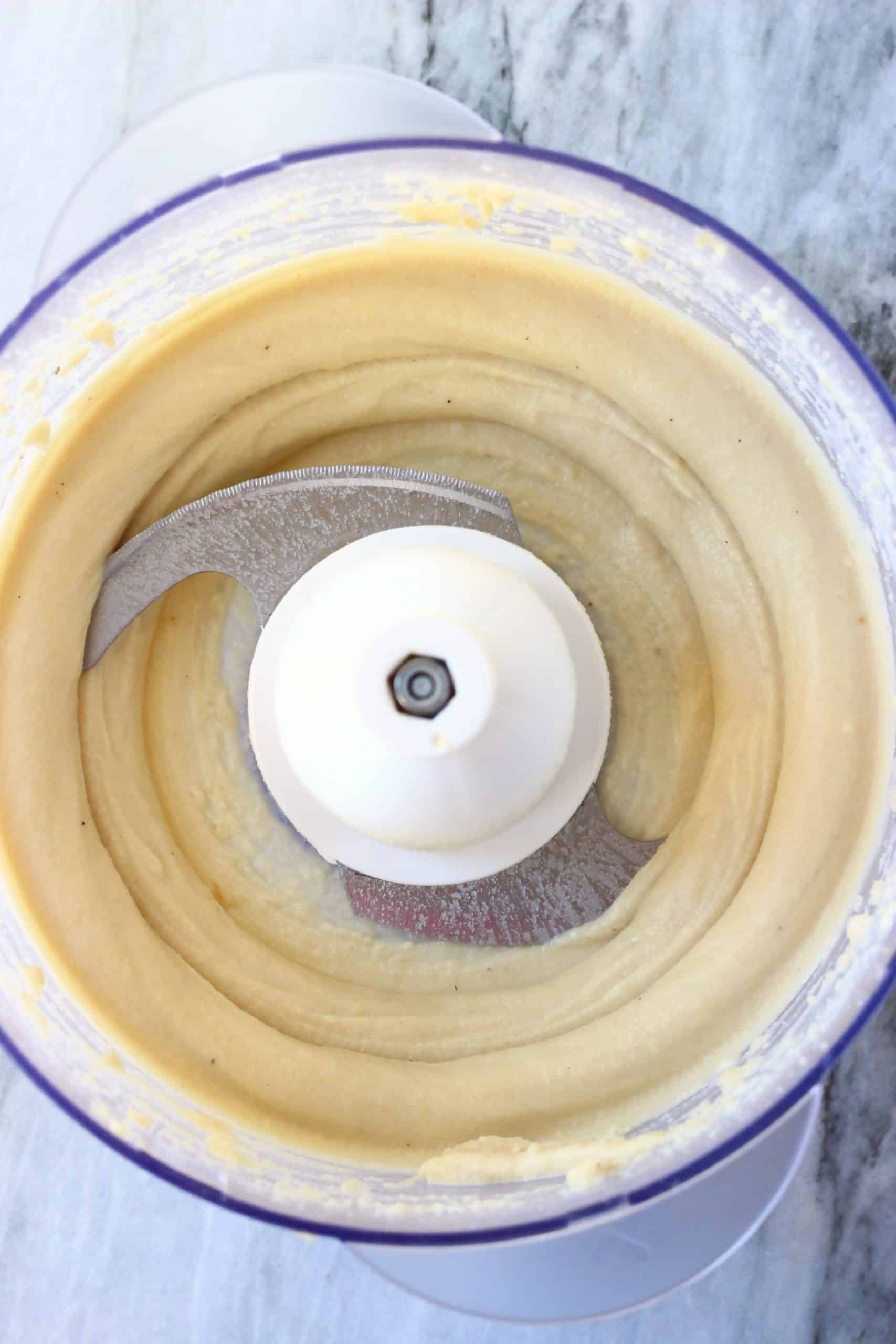 Gluten-free vegan homemade oreos cream in a food processor