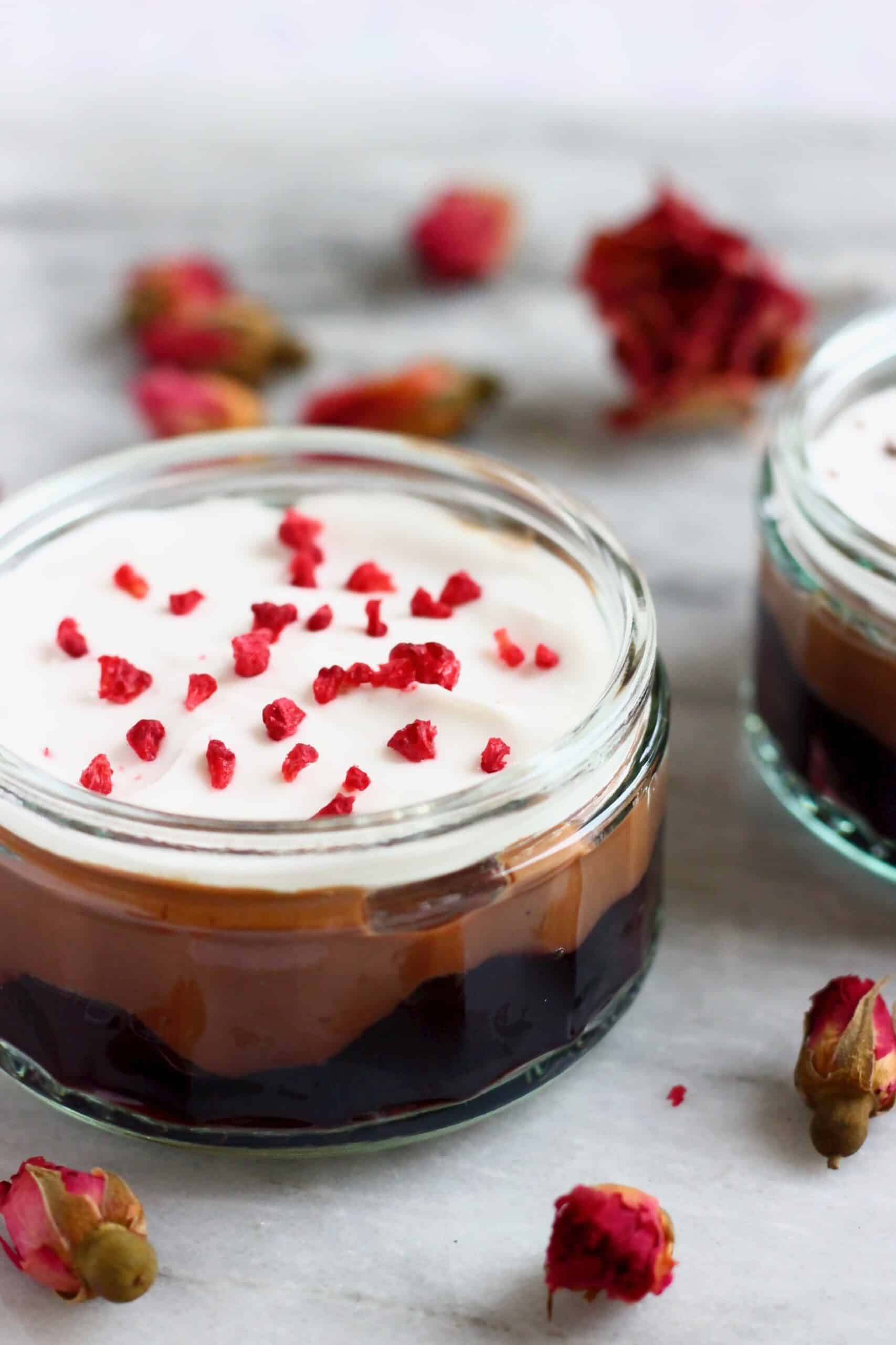A gluten-free vegan chocolate cherry trifle in a glass pot