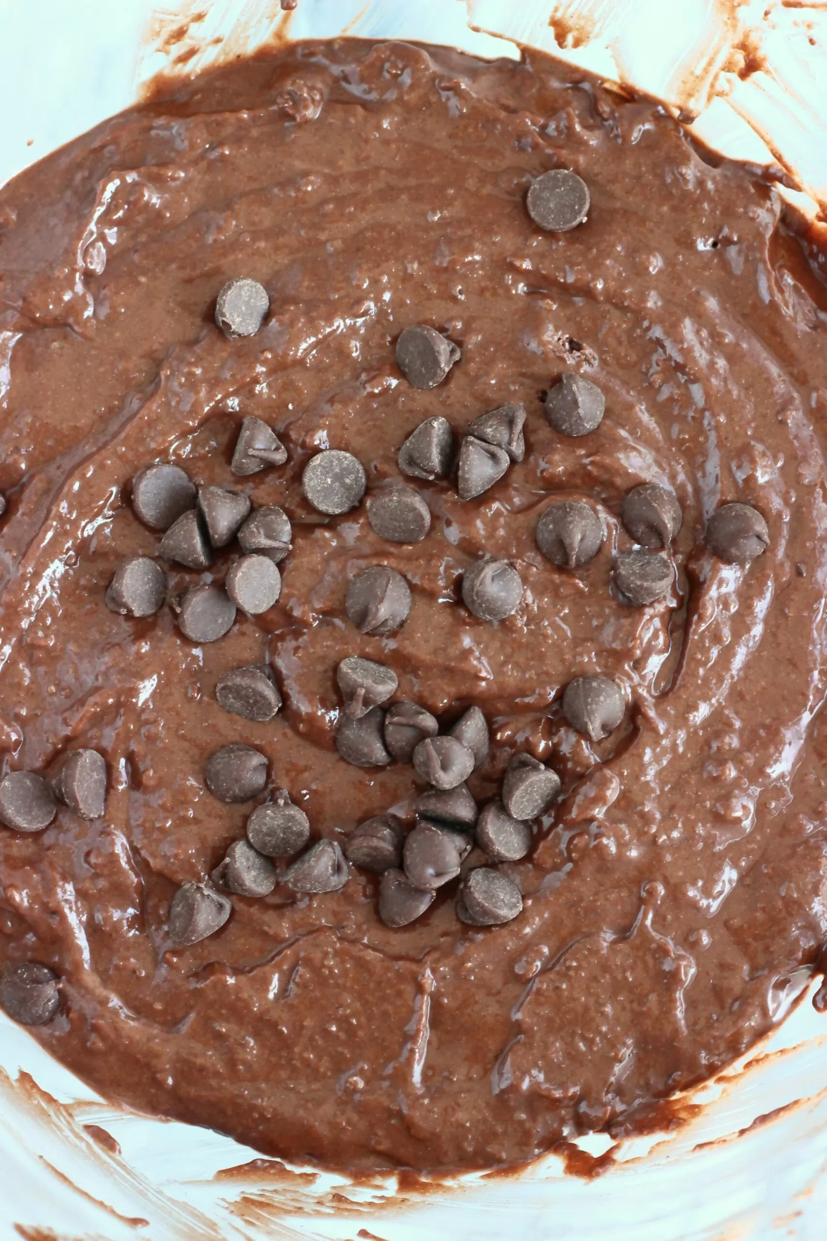 Gluten-free vegan chocolate bread batter with chocolate chips in a mixing bowl