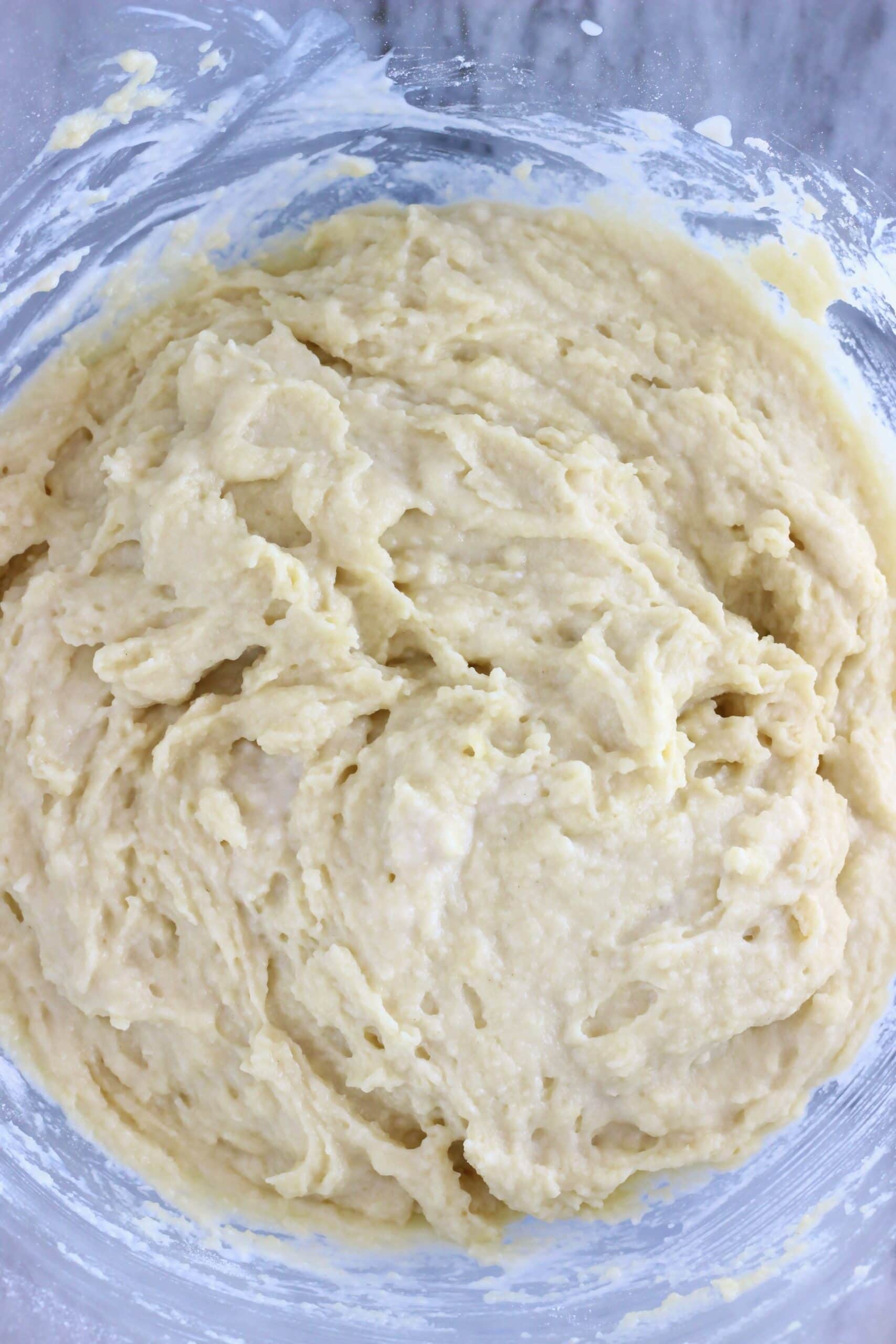 Raw gluten-free vegan olive oil cake batter in a glass mixing bowl