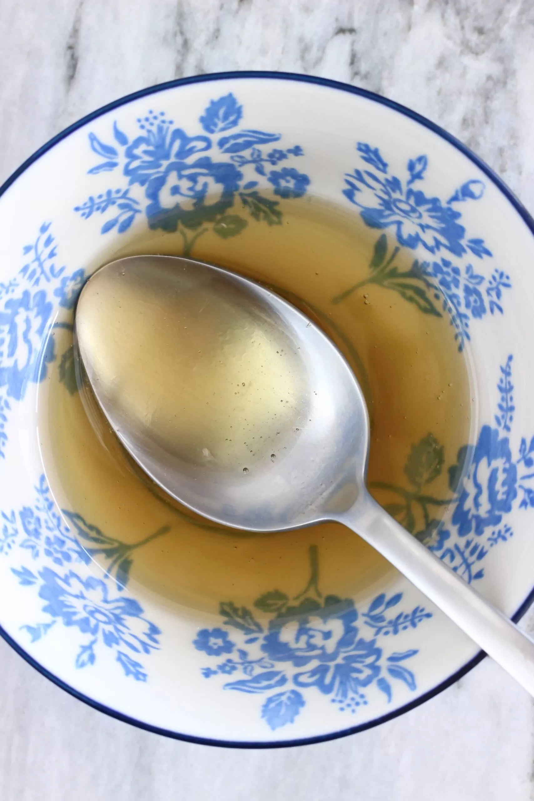 Lemon juice and maple syrup in a bowl with a spoon