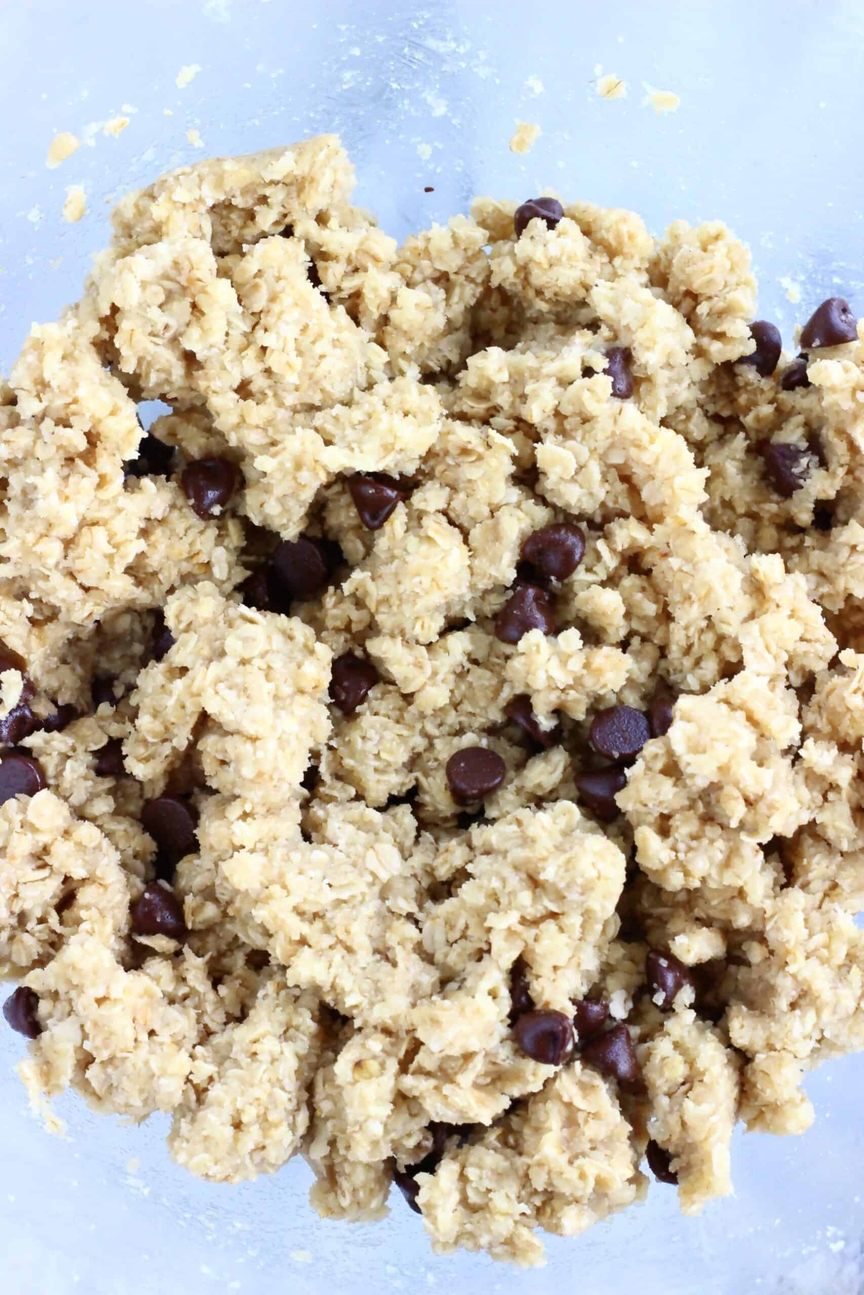 Raw gluten-free vegan oatmeal chocolate chip cookie bars batter in a bowl