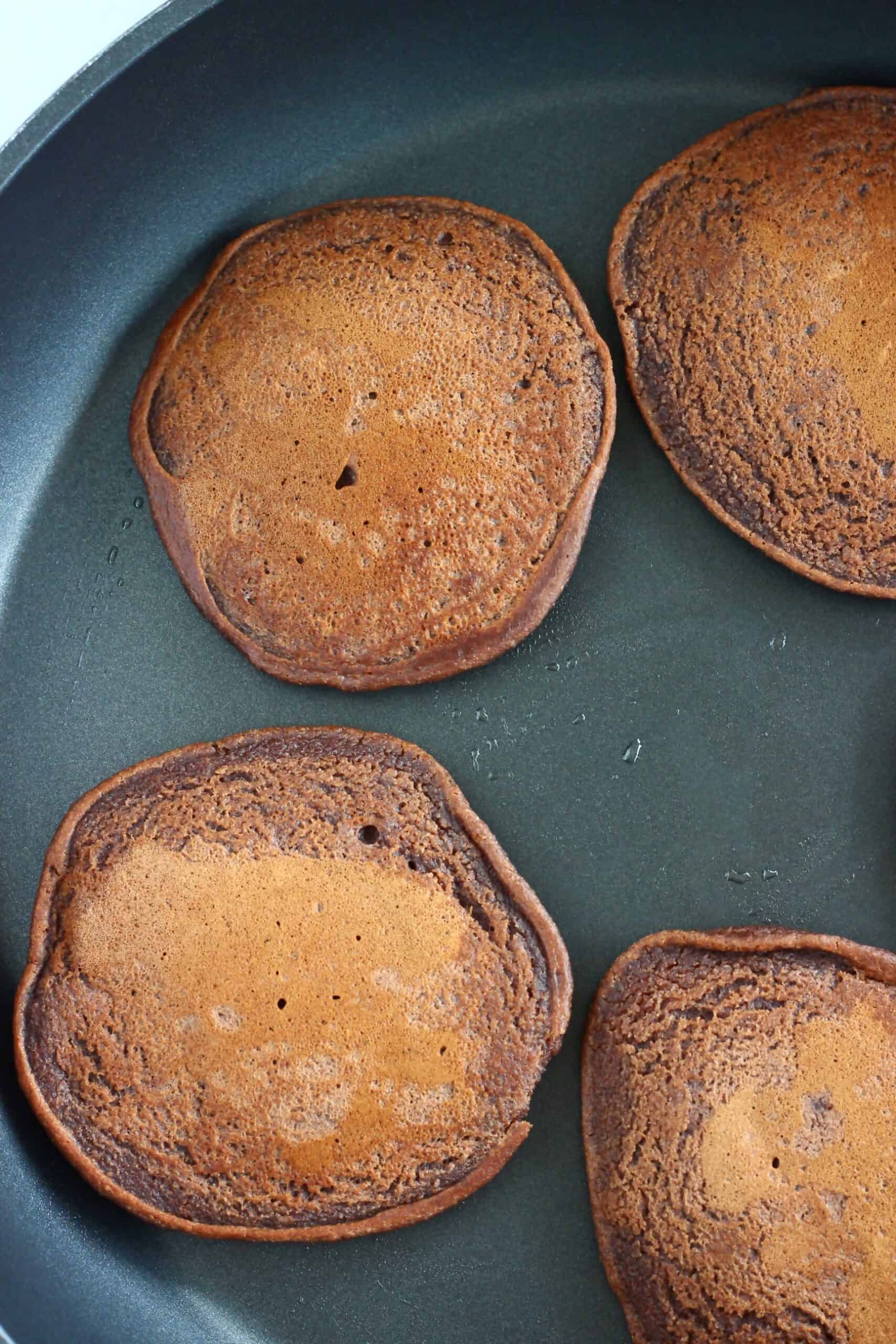 Gluten-free vegan chocolate pancakes in a frying pan