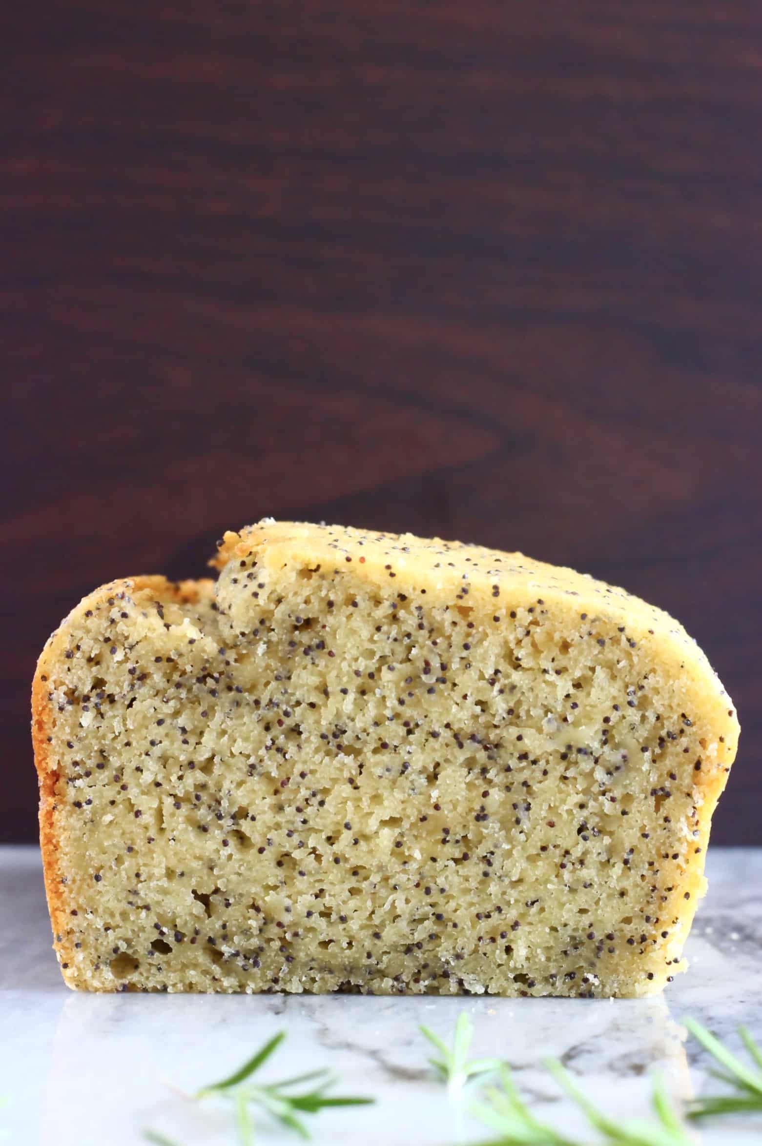 A cross-section of a sliced loaf of gluten-free vegan orange poppy seed bread